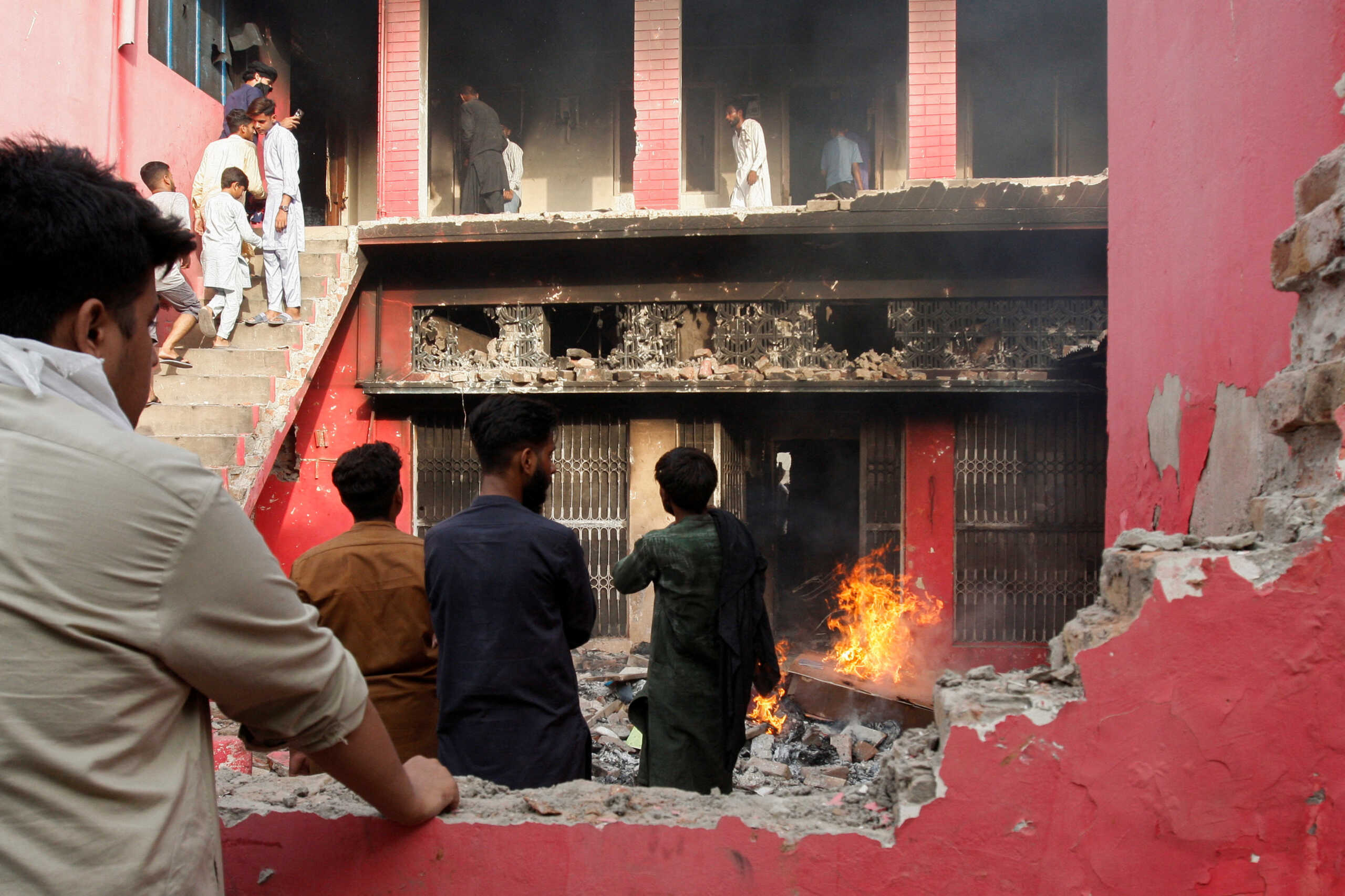 People gather at a church building vandalized by protesters in Jaranwala, Pakistan August 16, 2023 REUTERS