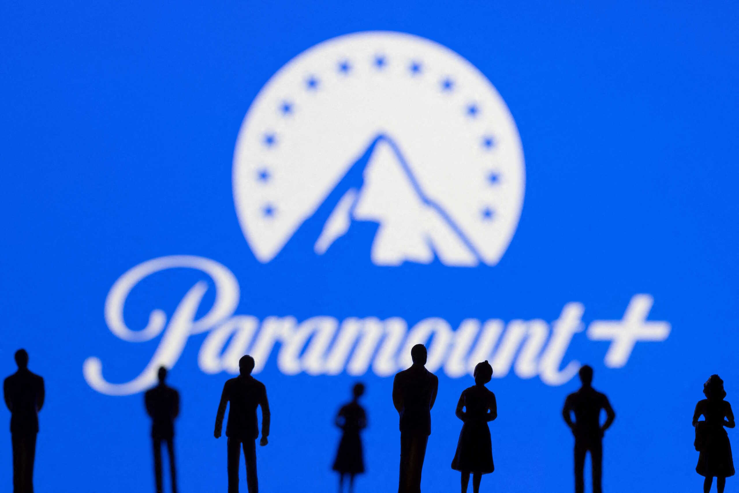 FILE PHOTO: Toy figures of people are seen in front of the displayed Paramount + logo, in this illustration taken January 20, 2022. REUTERS
