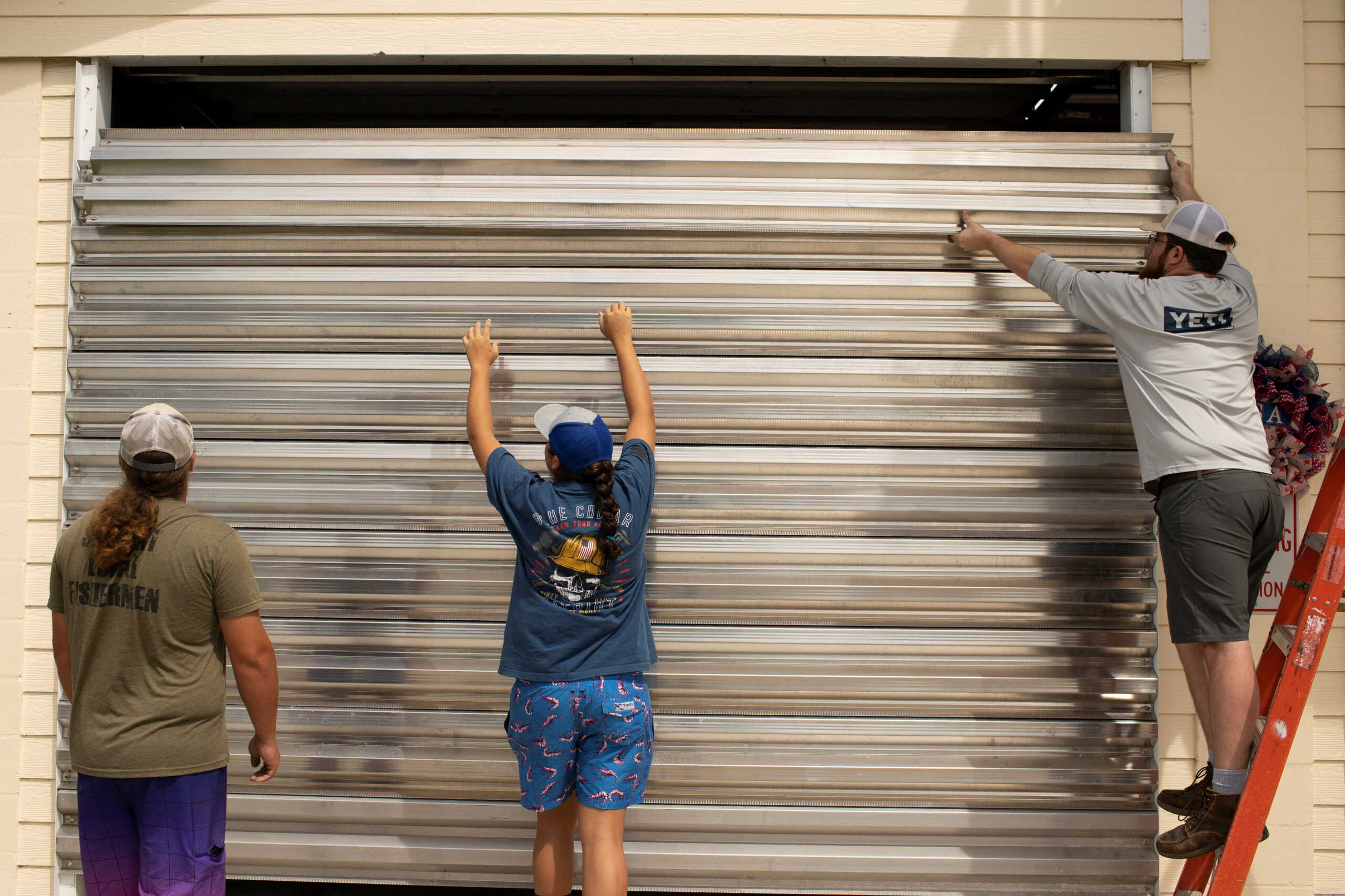 Volunteers place hurricane shutters at the Cedar Key Fire Station ahead of the arrival of Hurricane Idalia, in Cedar Key, Florida, U.S., August 29, 2023. REUTERS