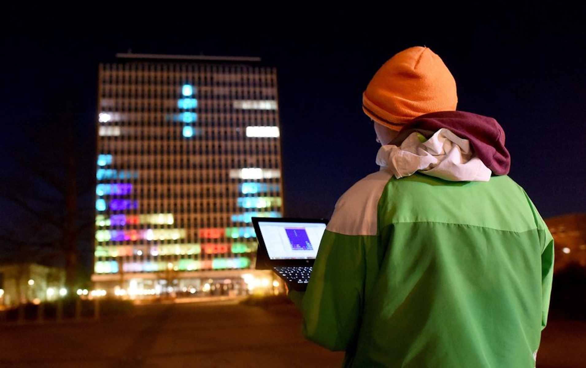 epa05235890 Student Merlin Koetzing from Kiel plays the computer game Tetris on the high-rise at the university in Kiel, Germany, 22 March 2016 (issued 30 March 2016). As part of their project 'Lighthouse,' students from the Christian Albrecht University (CAU) have installed 57,000 LED lights on 392 windows of the 14-story high-rise and can now play various computer games with it.  EPA