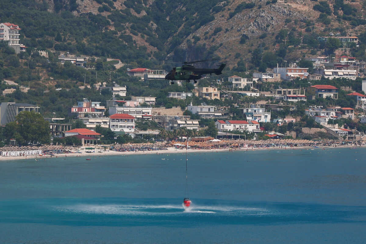 Military members of emergency services work to contain a wildfire near Qeparo, Albania, August 19, 2023. REUTERS