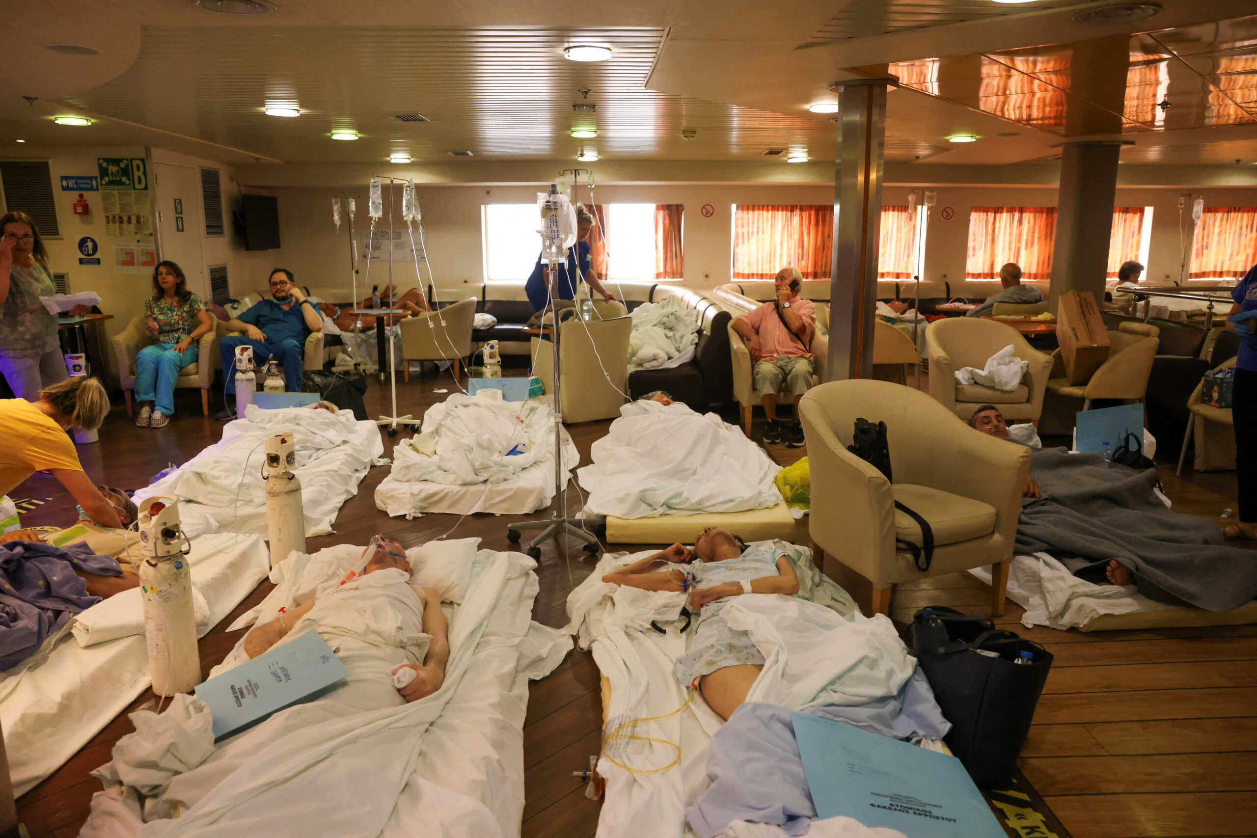 Patients from the General University Hospital of Alexandroupolis are seen inside a ferry after being evacuated, as a wildfire rages in Alexandroupolis, on the region of Evros, Greece, August 22, 2023. REUTERS