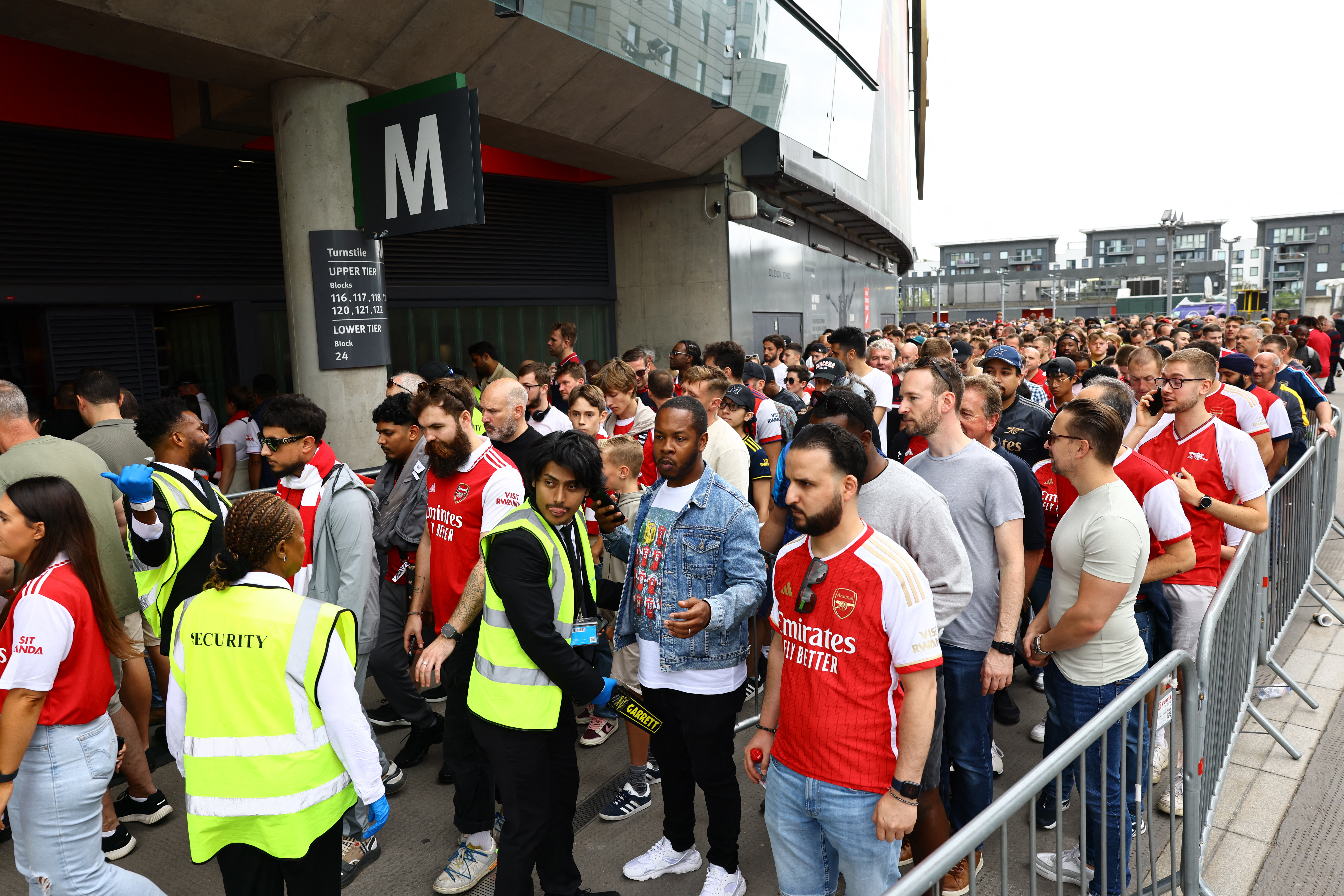 Soccer Football - Premier League - Arsenal v Nottingham Forest - Emirates Stadium, London, Britain - August 12, 2023 Arsenal fans are pictured queuing outside the stadium as the match is delayed due to an issue with the ticketing system REUTERS