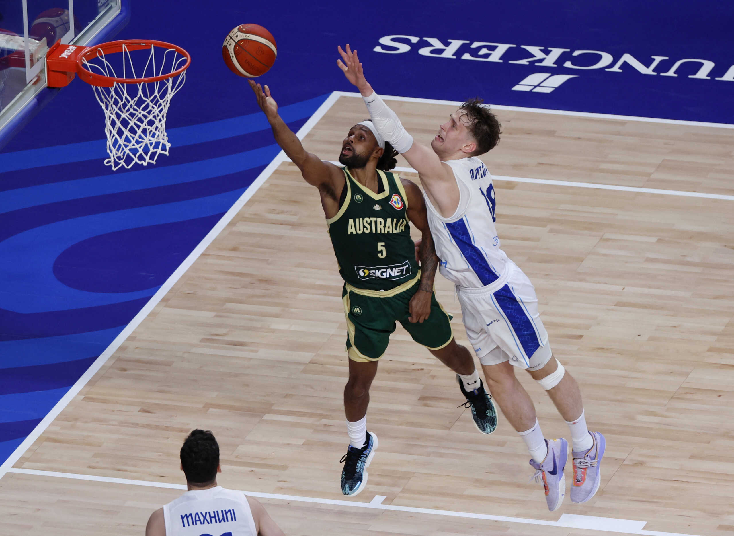 Basketball - FIBA World Cup 2023 - First Round - Group E - Finland v Australia - Okinawa Arena, Okinawa, Japan - August 25, 2023 Australia's Patty Mills in action with Finland's Mikael Jantunen REUTERS