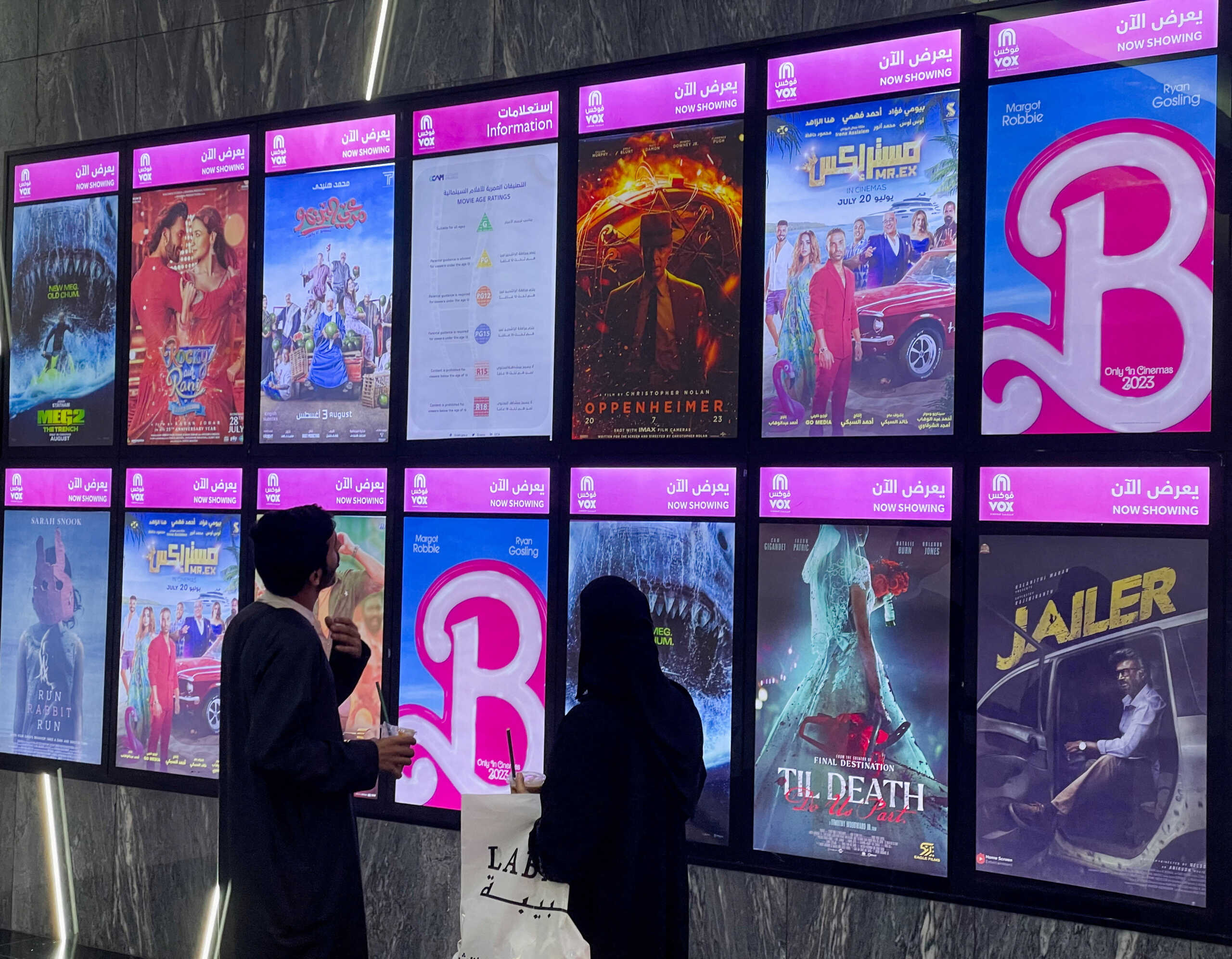 People watch the billboard during "Barbie" first screening at VOX Cinemas, in Riyadh, Saudi Arabia, August 10, 2023. REUTERS