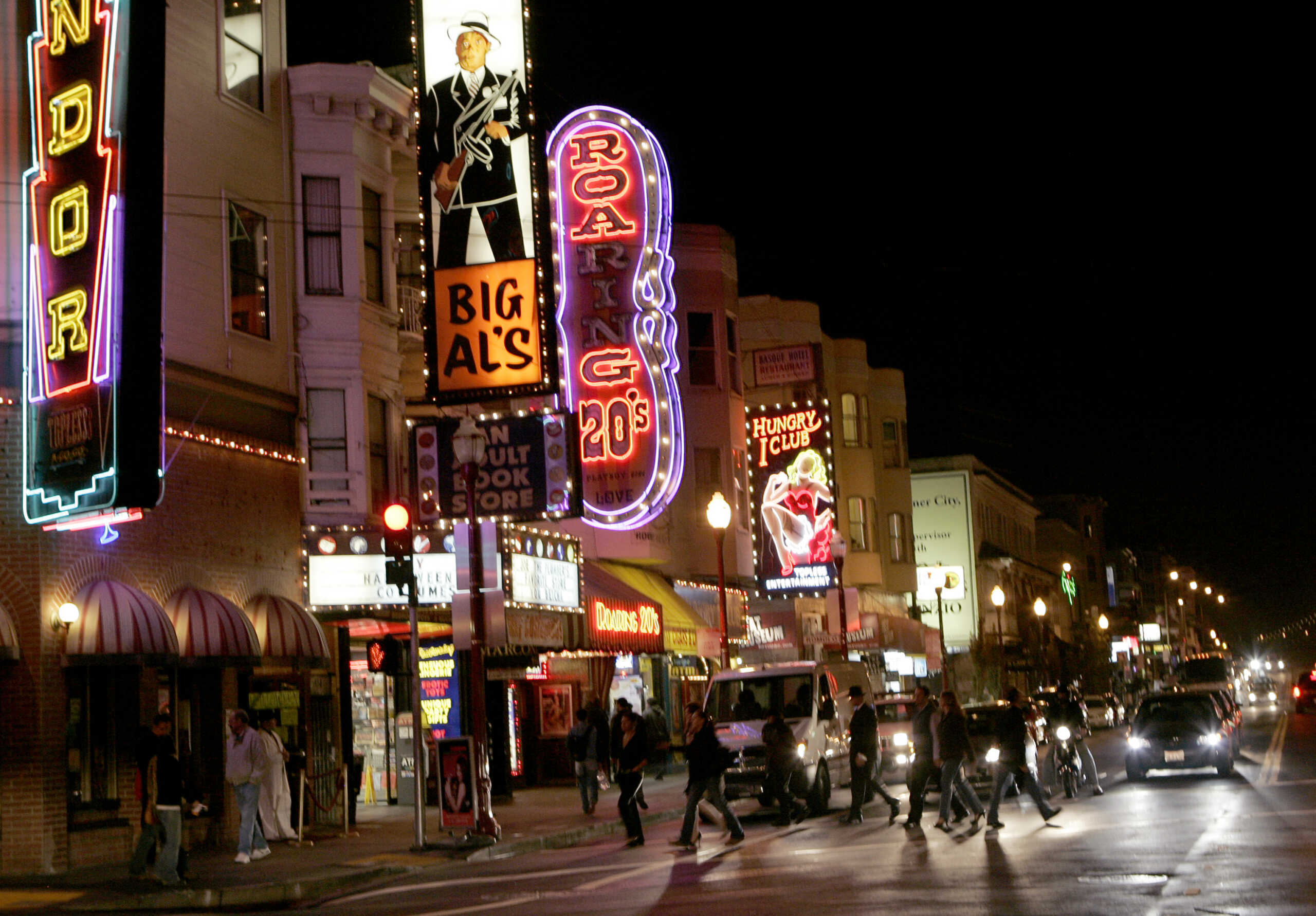 People walk through an intersection along Broadway Street in the North Beach neighborhood in San Francisco, California October 30, 2008.  REUTERS