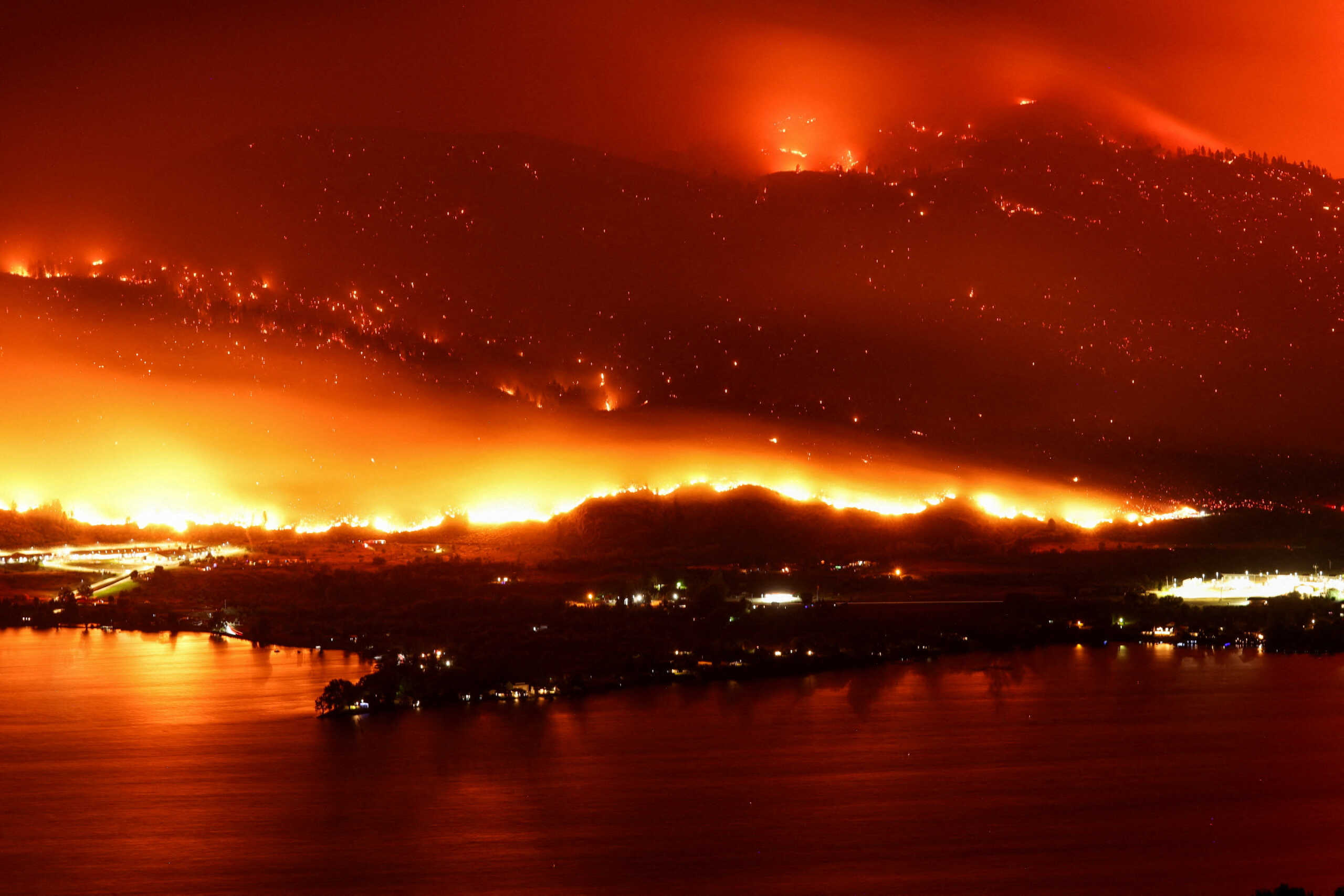 FILE PHOTO: A long exposure image shows the Eagle Bluffs Wildfire, which crossed the border from the U.S. state of Washington, and prompted evacuation orders in Osoyoos, British Columbia, Canada July 30, 2023. REUTERS