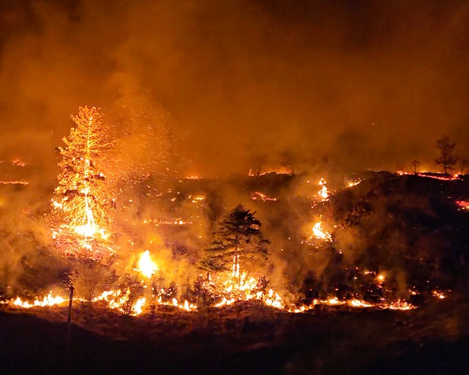 A view shows wildfires in West Kelowna, British Columbia, Canada August 17, 2023, in this screen grab obtained from a social media video. Youtube@DevonspittleREAL