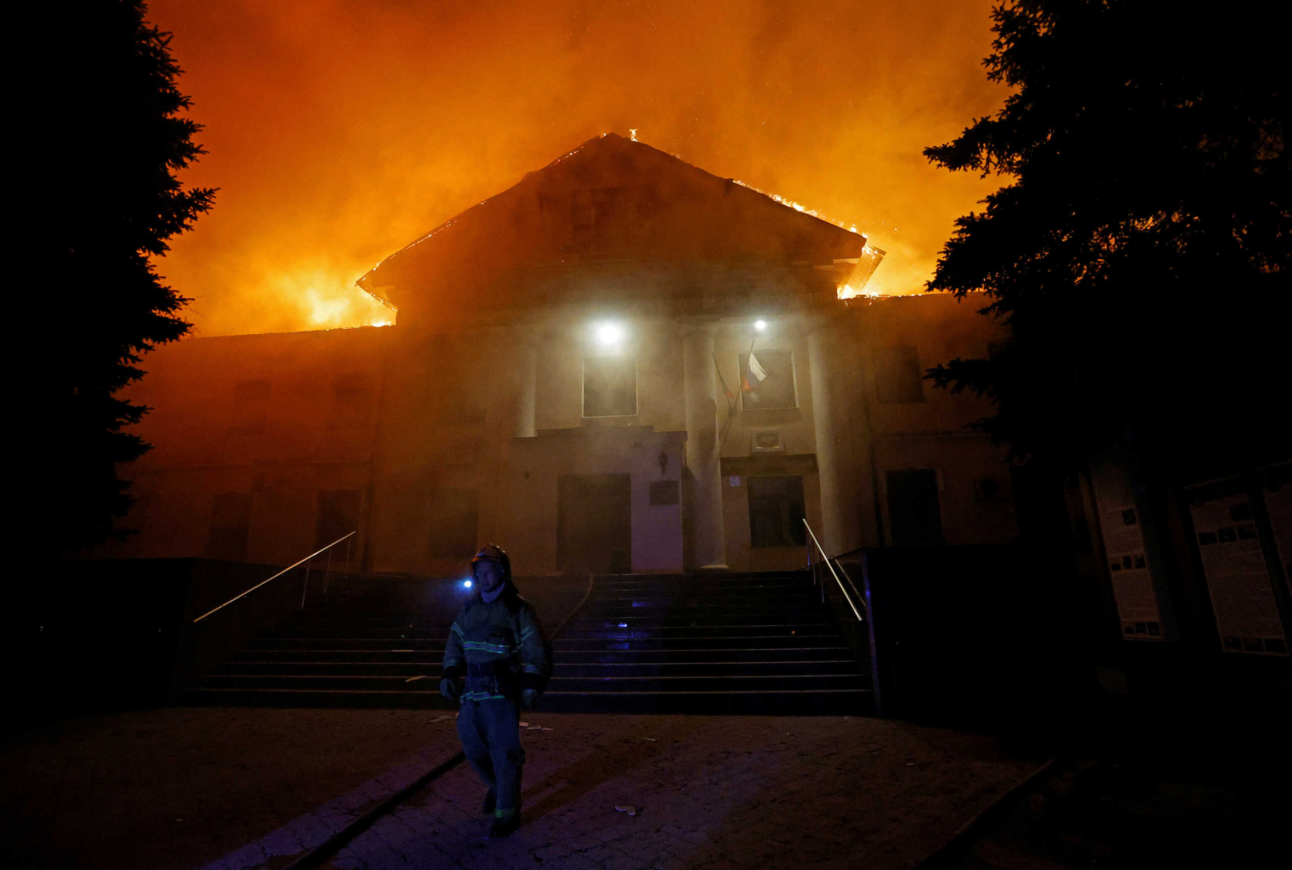 A firefighter works to extinguish a fire in the university building following a reported shelling in the course of Russia-Ukraine conflict in Donetsk, Russian-controlled Ukraine, August 5, 2023. REUTERS