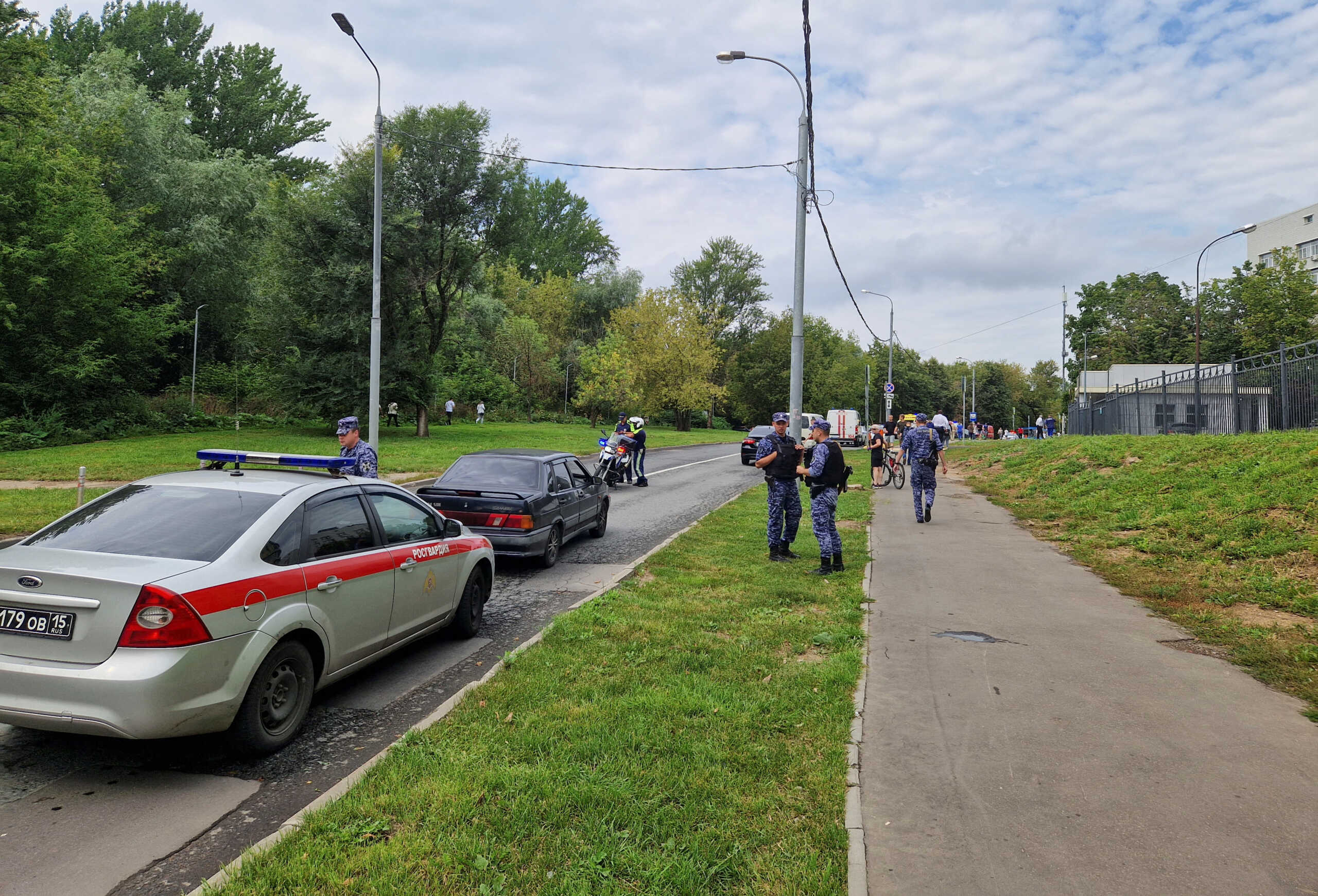 Russian law enforcement officers stand guard near the accident scene following a reported Ukrainian drone crash in Moscow, Russia, August 11, 2023. REUTERS
