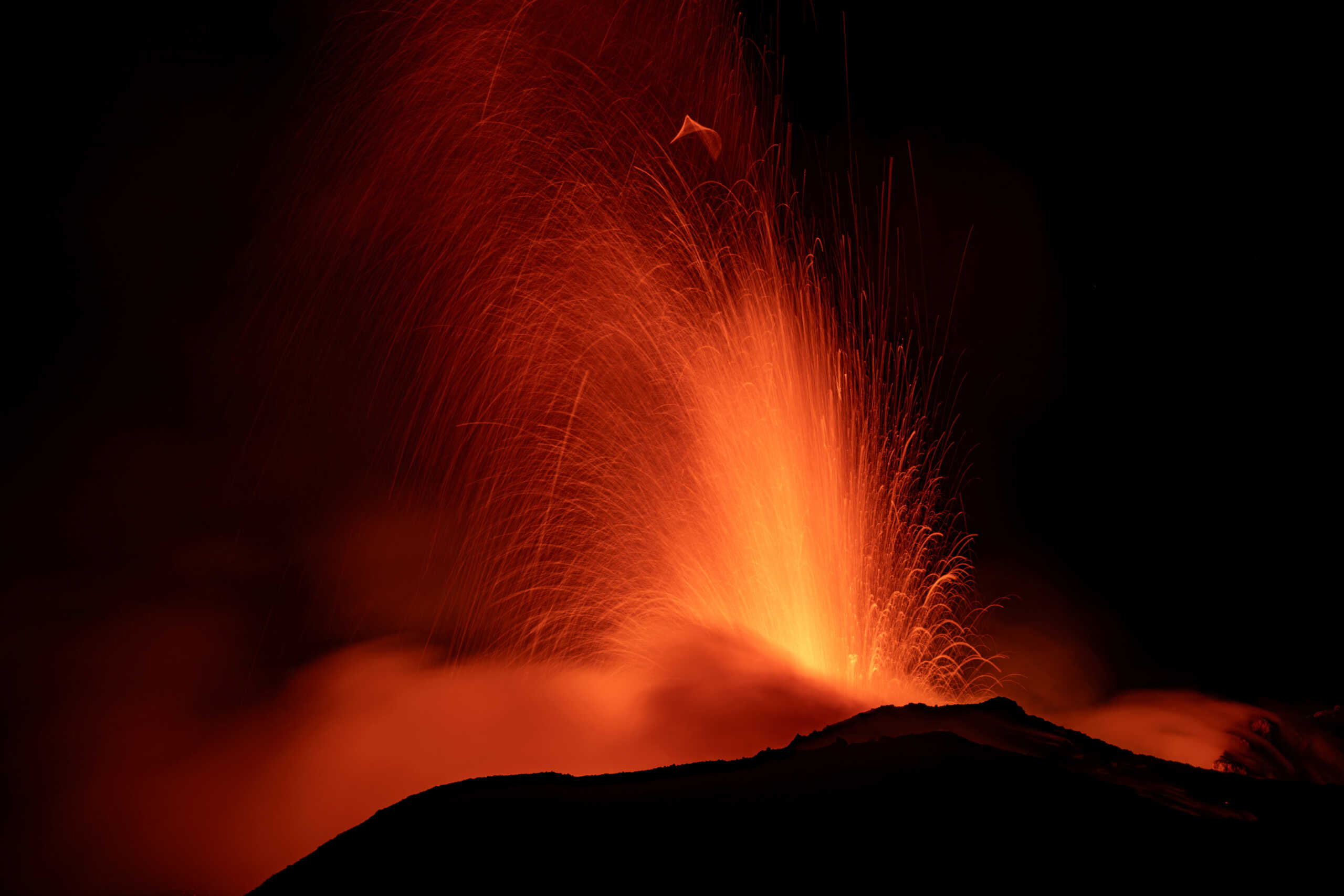 Mount Etna, Europe's most active volcano, lights up the night sky with eruptions as seen from Rocca Della Valle, Italy, August 13, 2023. Etna Walk
