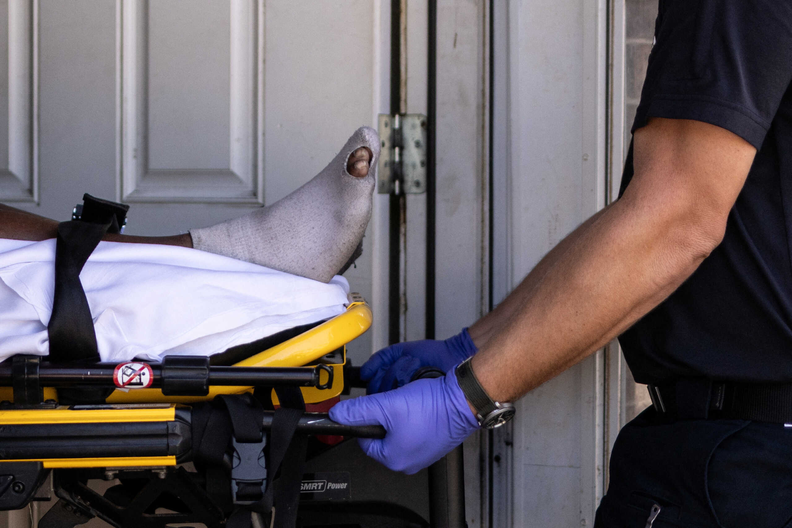 Paramedics with the Galveston County Health District transport a man who they said overheated and fell in his kitchen during a heat wave in Galveston, Texas, U.S., August 27, 2023.  REUTERS