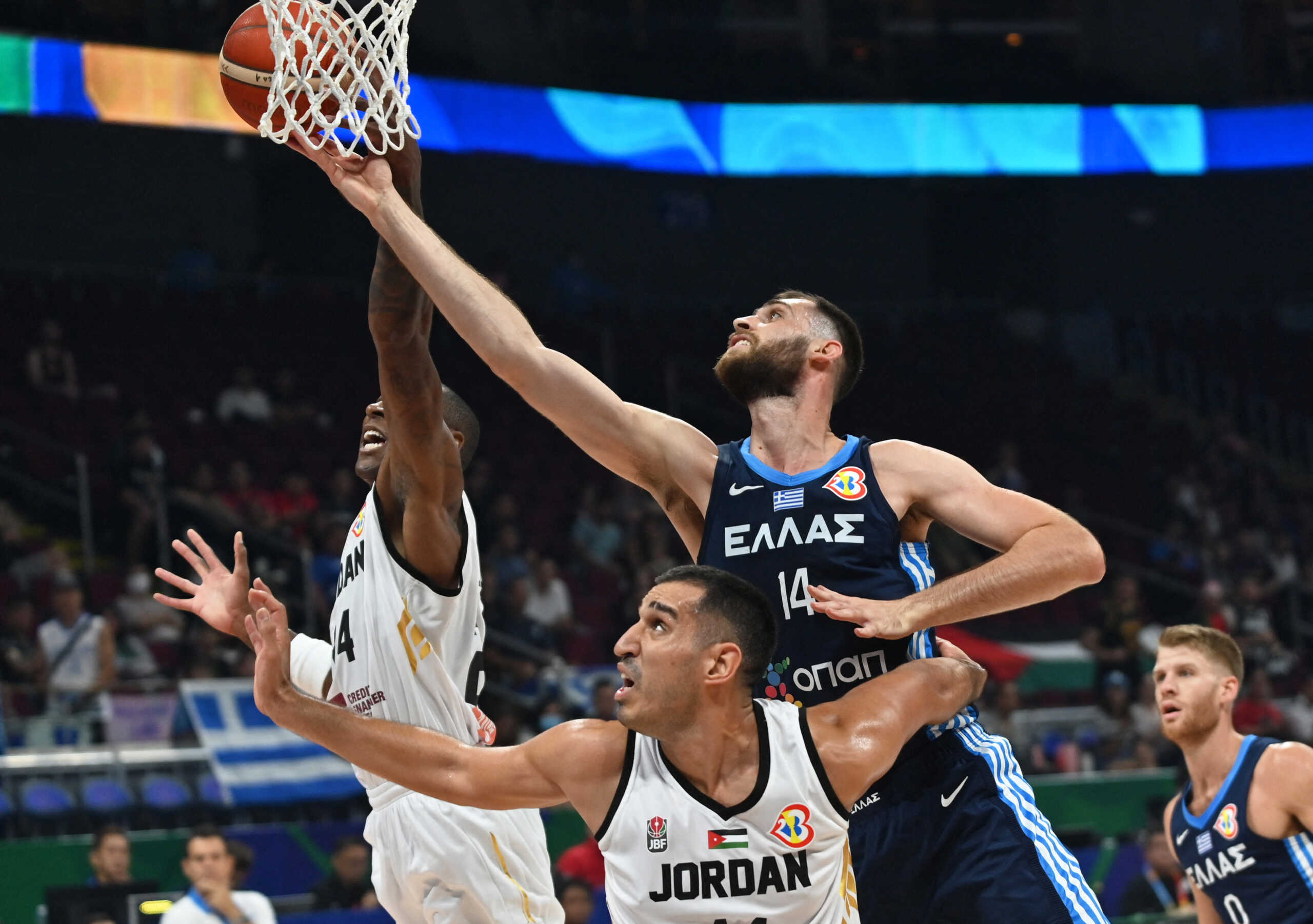 Basketball - FIBA World Cup 2023 - First Round - Group C - Jordan v Greece - Mall of Asia Arena, Manila, Philippines - August 26, 2023 Greece's Georgios Papagiannis in action with Jordan's Ahmad Dwairi REUTERS