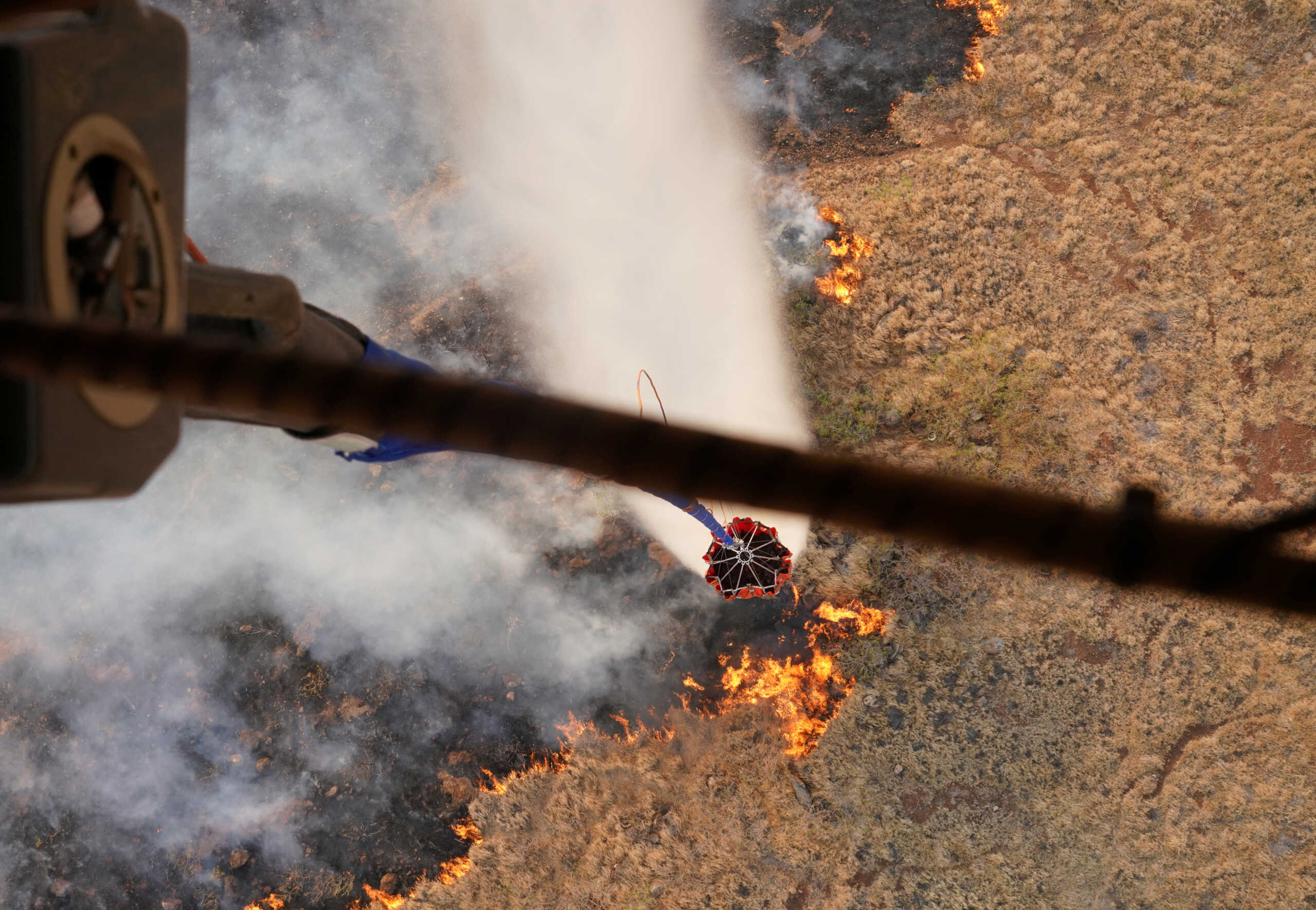 Hawaii Army National Guard CH47 Chinook helicopters perform aerial water bucket drops on the island of Maui to assist with fight of wildfires in Maui, Hawaii, August 9, 2023. Hawaii National Guard