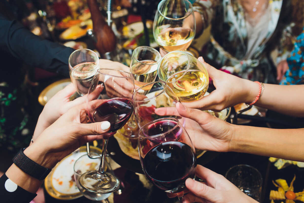 Champagne glasses in hands of people at party