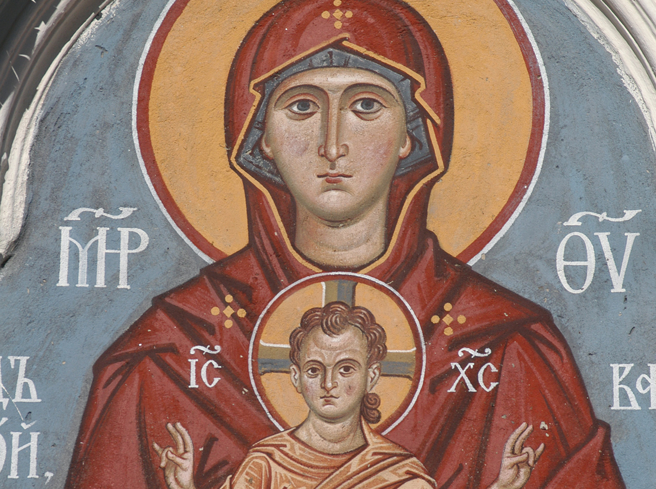 The Virgin and Child, an ancient fresco above the gate of an orthodox church in Pskov, Russia.