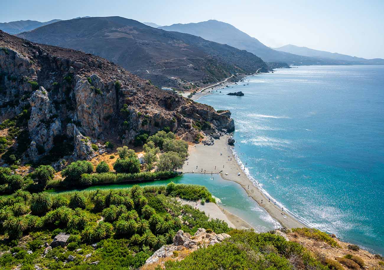 View of famous Preveli beach in the summer, Crete, Greece. Famous beach with river and palm trees in Libyan sea.