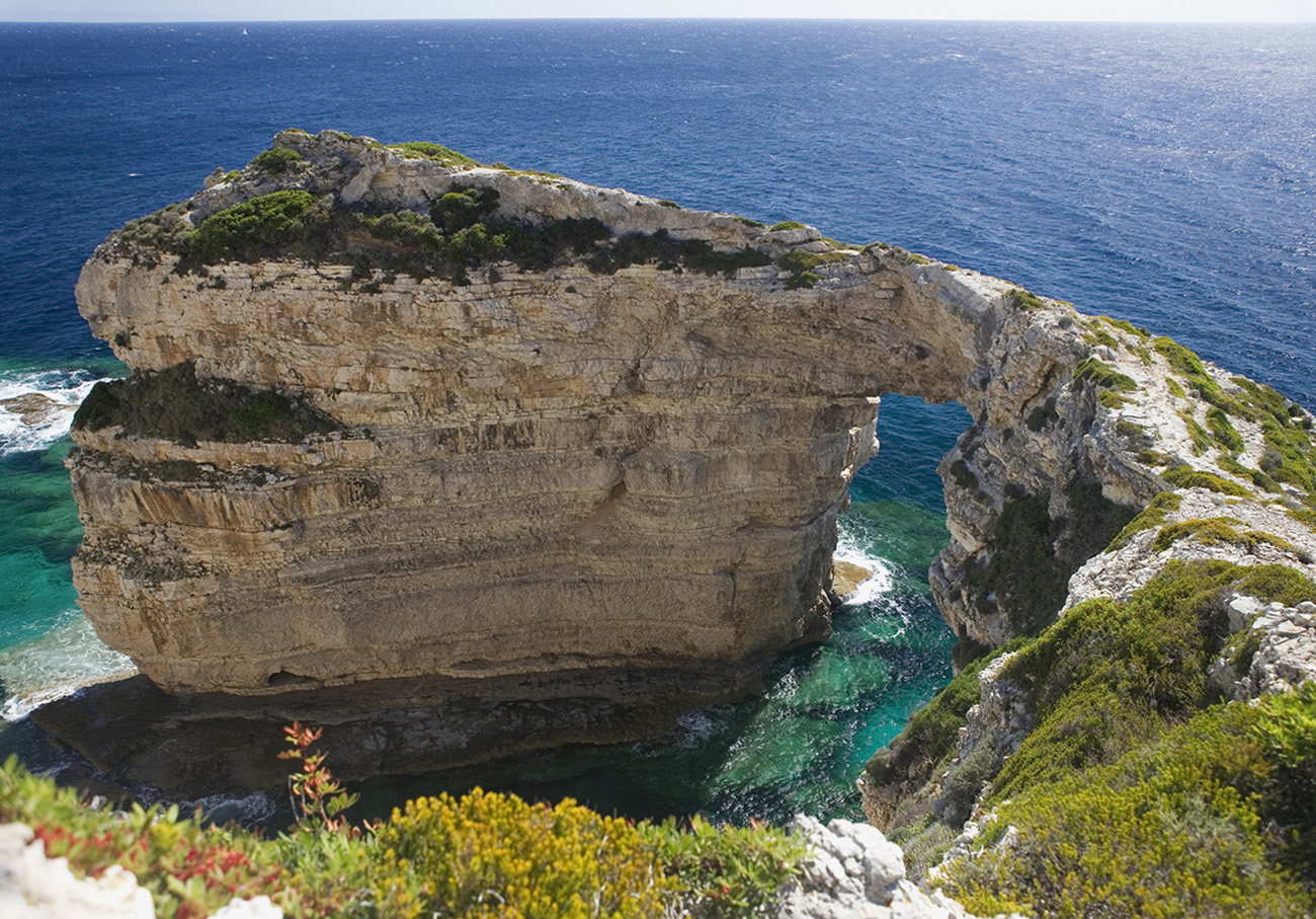 Landward view from above of the famous Tripitos Arch, Paxos, Ionian Islands, Greece.  It is over 20 metres high, and has magnificently clear waters around its base