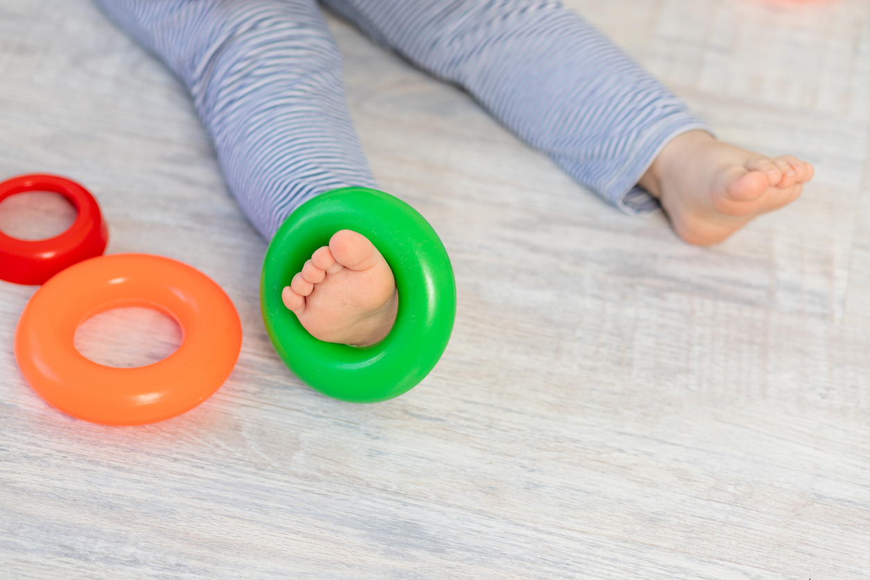 leg of a small child with toys