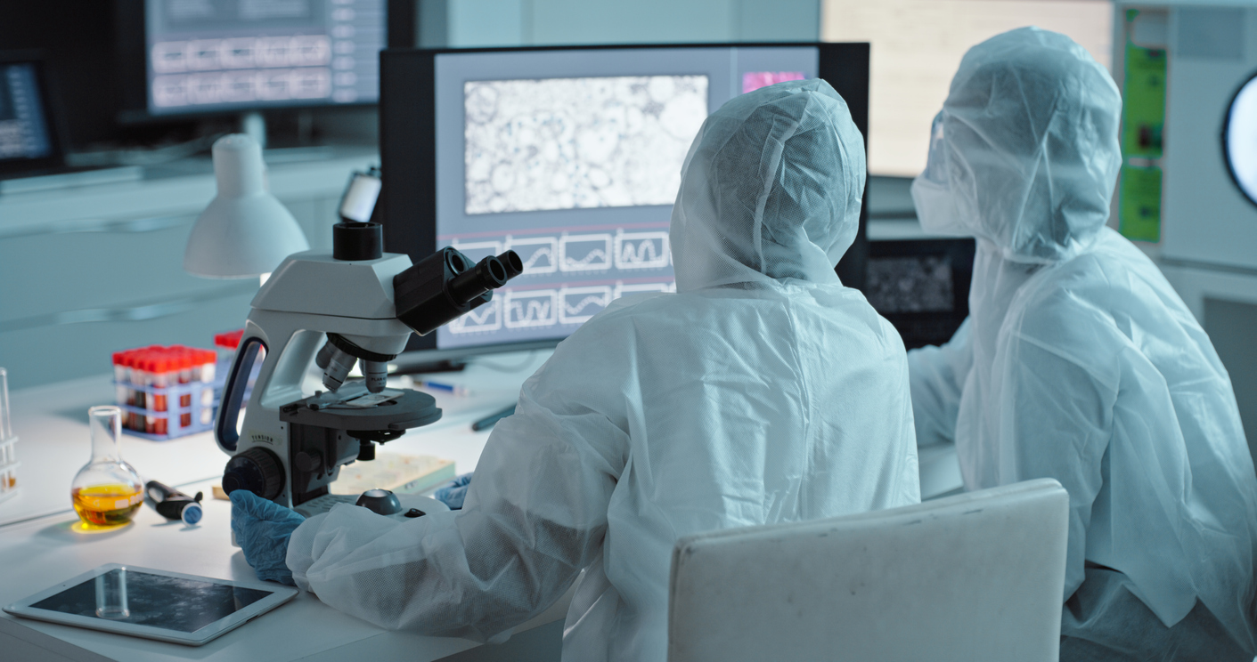 Collaboration, science and computer with a doctor women team in a laboratory for covid research in ppe uniform. Teamwork, innovation and experiment with scientist females working together in a lab