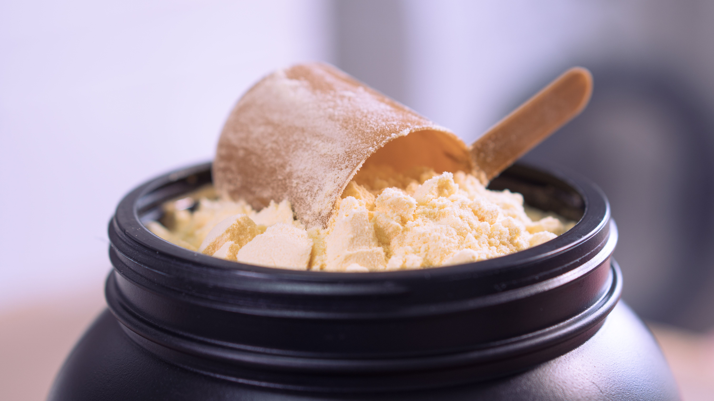 Container of milk whey protein. Close up.