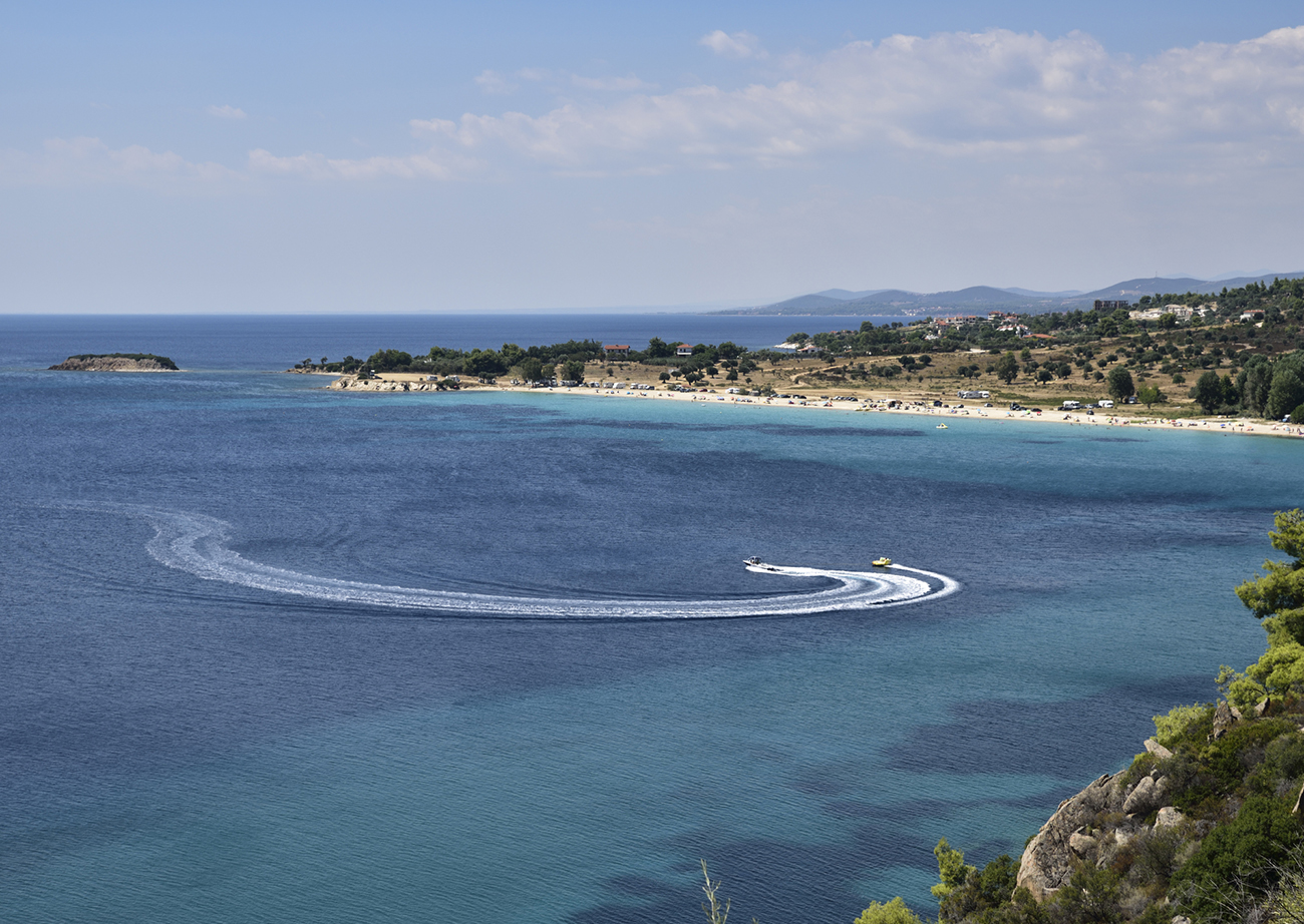 Unbelievable colors of Aegean sea and crystal pure and hot water at Ioaniss beach, on the west side of Sithonia, Halkidiki, Greece.