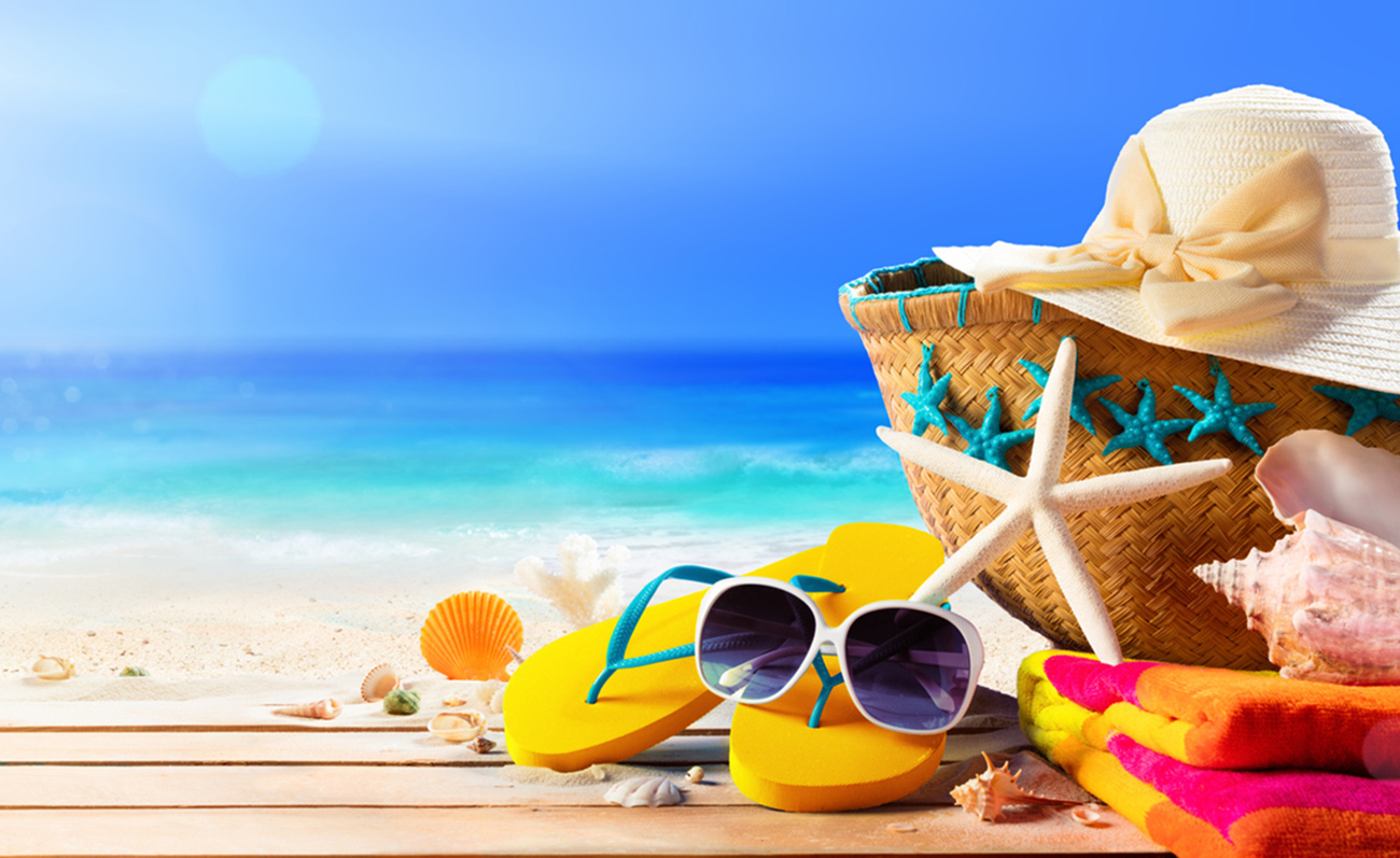 Sun Hat, Bag, Flip flops And Sunglasses On Seashore