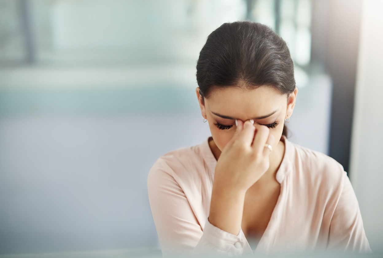 Shot of a young businesswoman experiencing a stressful day at work