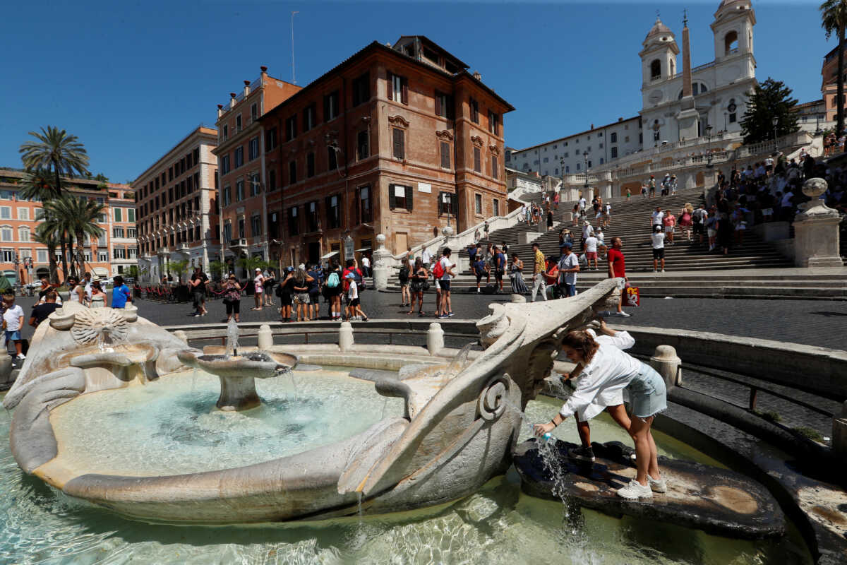 A woman fills her bottle with water from Fontana della Barcaccia near the Spanish Steps during a new heatwave as temperatures are expected to reach 40 degrees Celsius in some cities, in Rome, Italy August 21, 2023. REUTERS