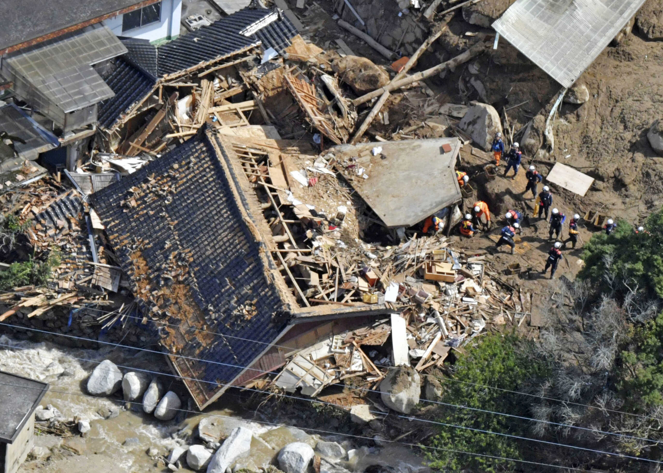 Photo taken from a helicopter shows a search and rescue operation continuing at the site of a mudslide following heavy rain in Karatsu, Saga Prefecture, Japan in this photo taken by Kyodo on July 11, 2023.  Mandatory credit Kyodo
