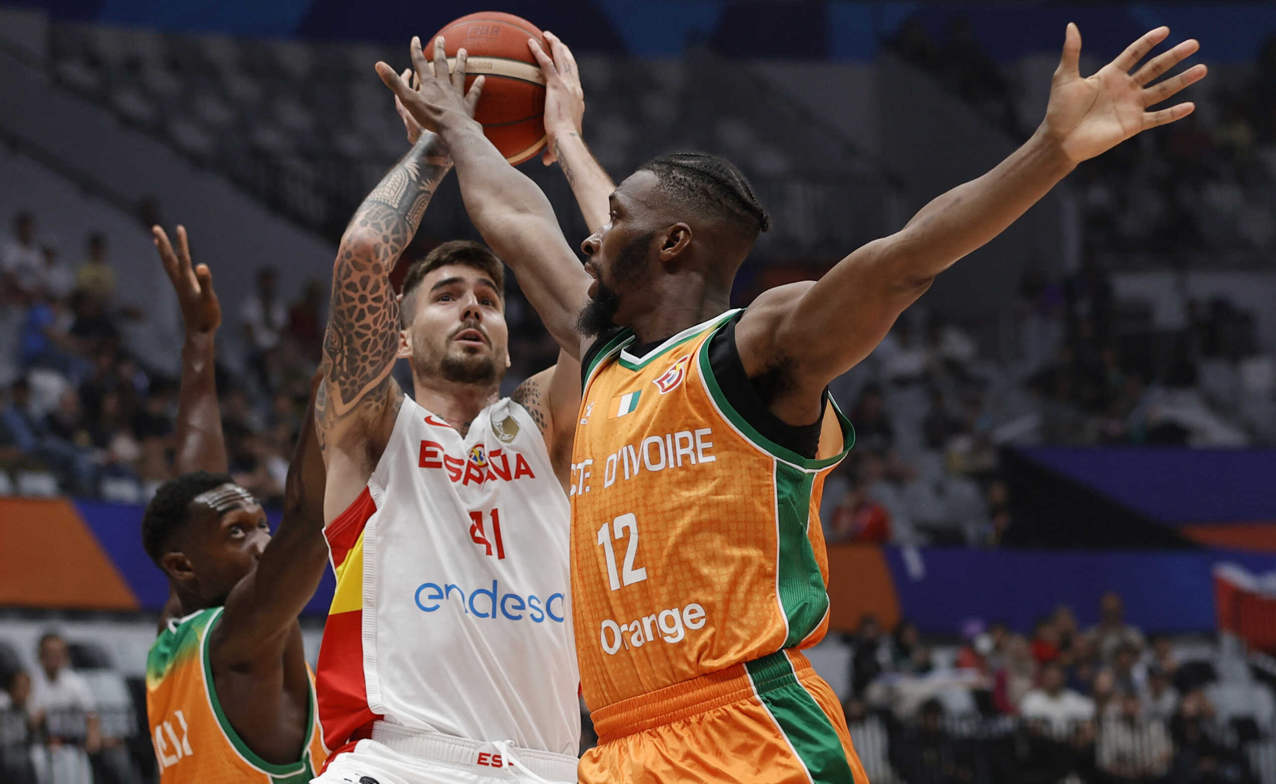 Basketball - FIBA World Cup 2023 - First Round - Group G - Spain v Ivory Coast - Indonesia Arena, Jakarta, Indonesia - August 26, 2023 Spain's Juancho Hernangomez in action with Ivory Coast's Vafessa Fofana REUTERS
