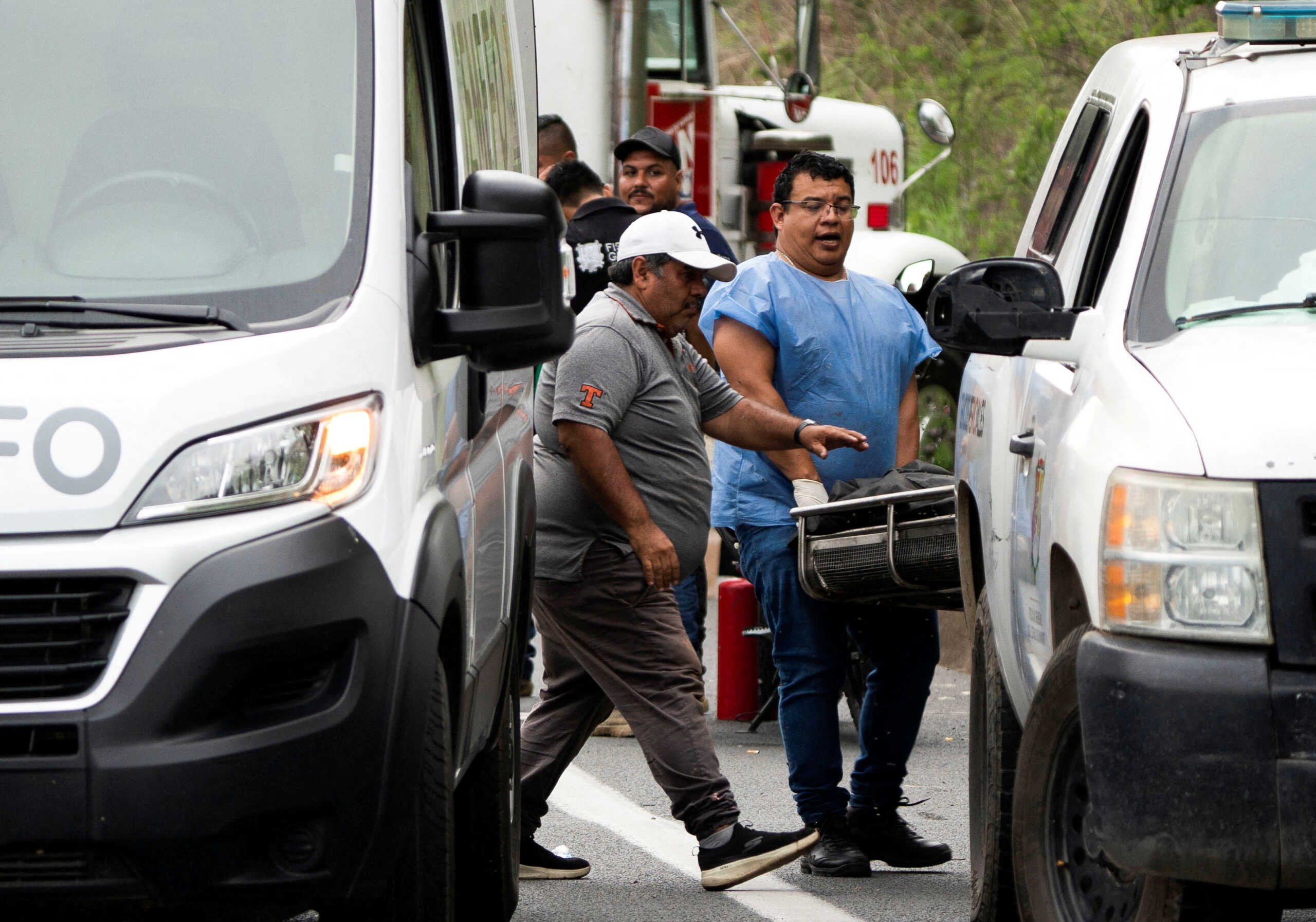 Forensic personnel move the body of one of the victims near the site where a passenger bus traveling towards Tijuana plunged off a highway killing several people, in Tepic, Mexico August 3,2023. REUTERS
