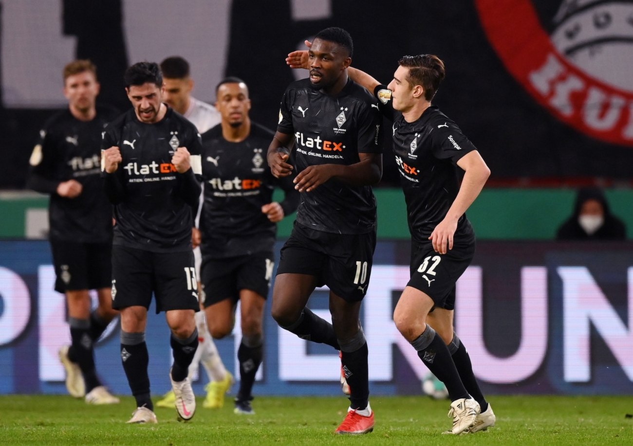 epa08985531 Marcus Thuram of Borussia Monchengladbach (2R) celebrates with Florian Neuhaus after scoring his team's first goal during the  DFB Cup Round of Sixteen match between VfB Stuttgart and Borussia Moenchengladbach at Mercedes-Benz Arena in Stuttgart, Germany, 03 February 2021.  EPA