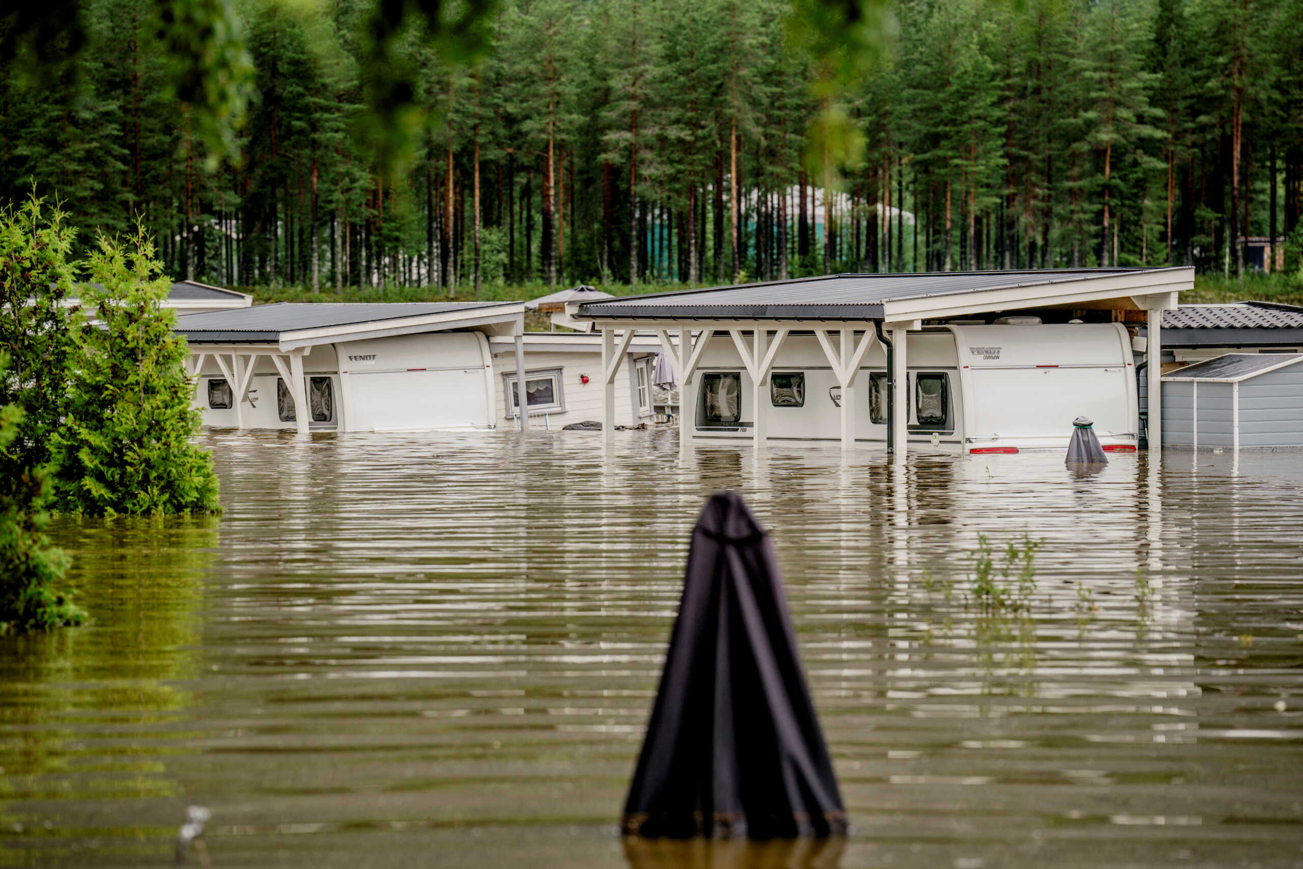 Parts of Dokka camping are completely flooded with water after the Dokka River overflowed its banks as the extreme weather "Hans" hits Eastern Norway with heavy rain, in Dokka, Norway, August 9, 2023. NTB