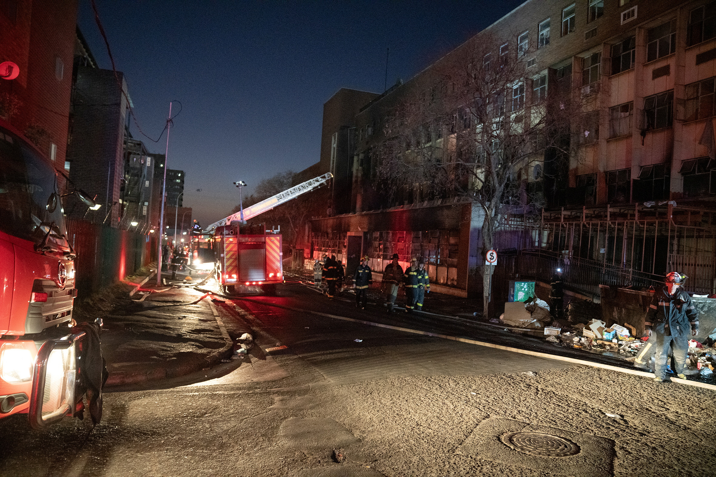 Fire fighters work at the scene of a deadly blaze in the early hours of the morning, in Johannesburg, South Africa August 31, 2023. REUTERS