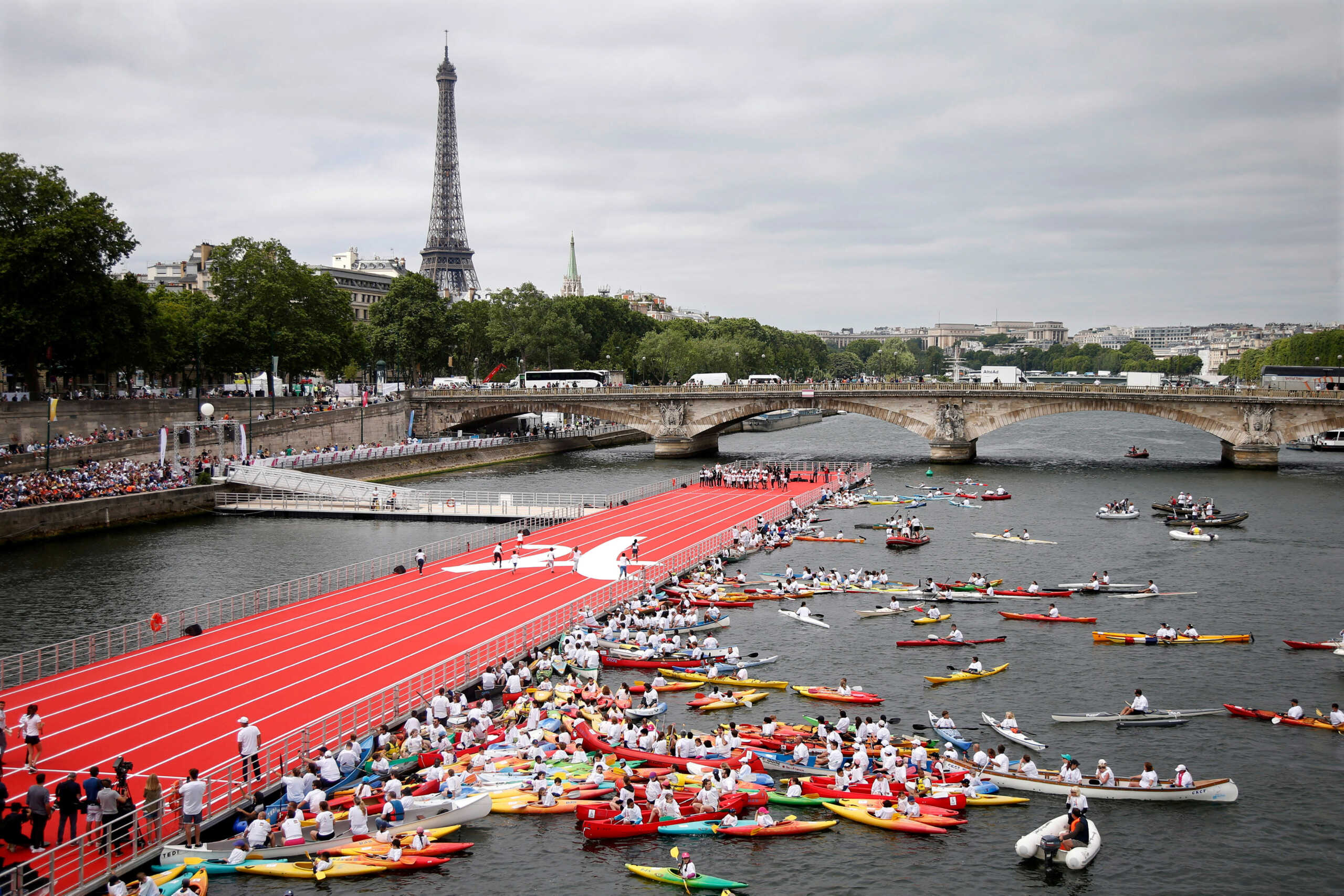 FILE PHOTO: A general view from the Pont Alexandre III bridge shows an athletics track that floats on the River Seine, with the Eiffel tower in the background, in Paris, France, June 23, 2017 as Paris is transformed  into a giant Olympic park to celebrate International Olympic Days with a variety of sporting events for the public across the city during two days as the city bids to host the 2024 Olympic and Paralympic Games.  REUTERS