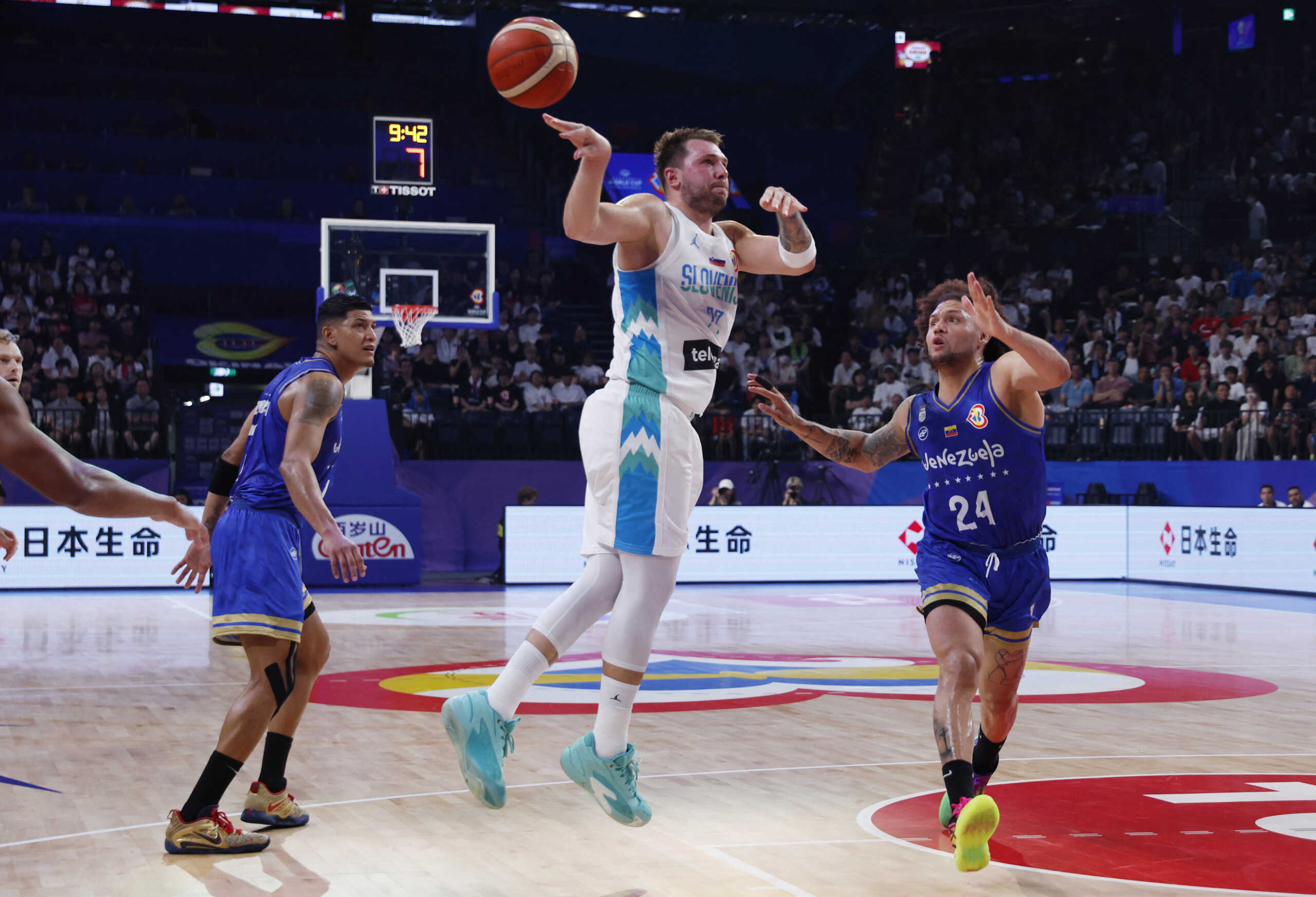 Basketball - FIBA World Cup 2023 - First Round - Group F - Slovenia v Venezuela - Okinawa Arena, Okinawa, Japan - August 26, 2023 Slovenia's Luka Doncic in action with Venezuela's Michael Carrera REUTERS