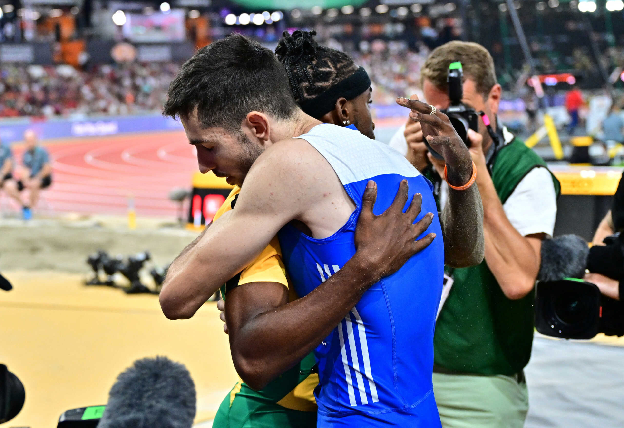 Athletics - World Athletics Championship - Men's Long Jump Final - National Athletics Centre, Budapest, Hungary - August 24, 2023  Greece's Miltiadis Tentoglou reacts after winning the gold medal in the men's long jump final with silver medallist Jamaica's Wayne Pinnock REUTERS