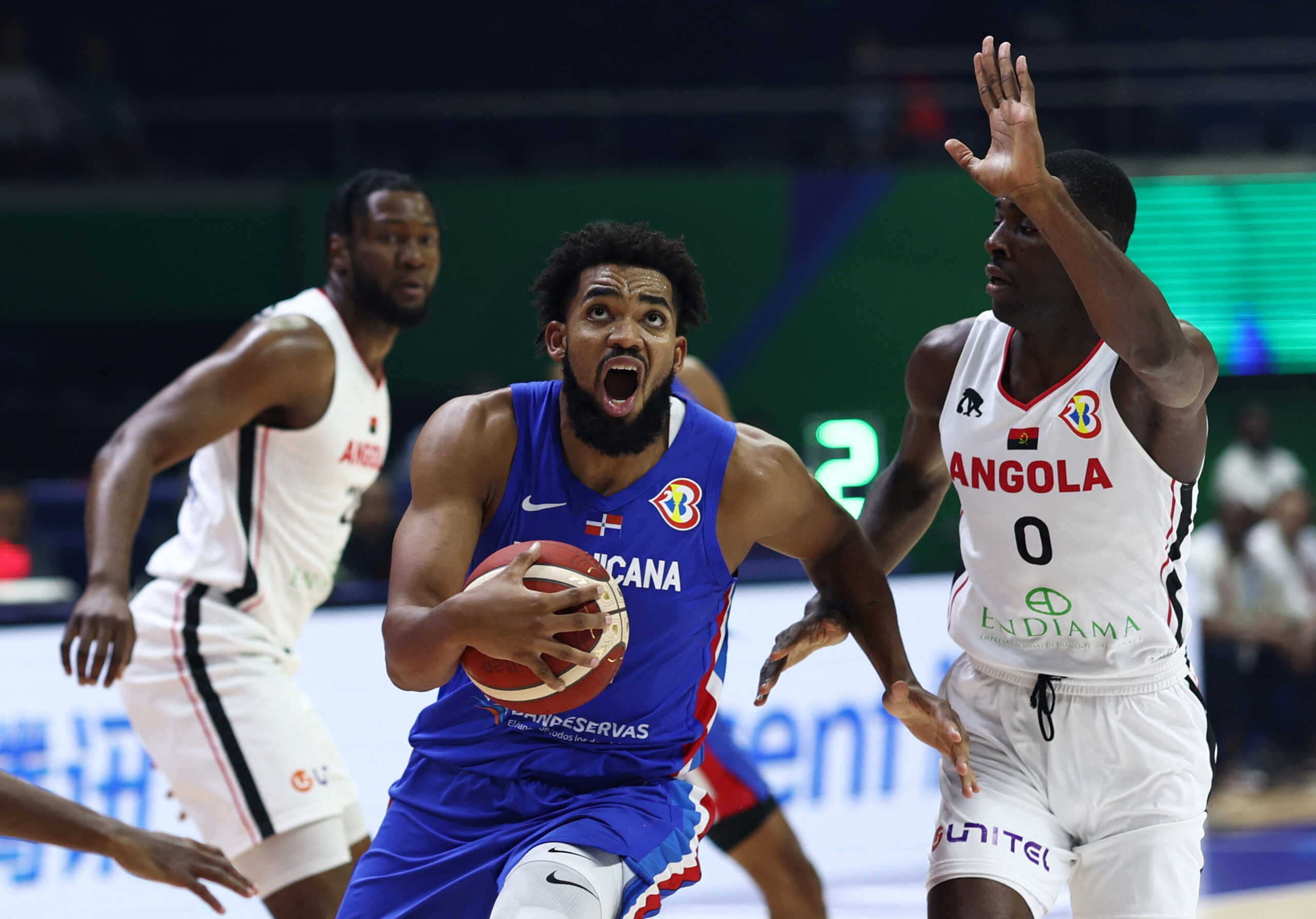 Basketball - FIBA World Cup 2023 - First Round - Group A - Angola v Dominican Republic - Araneta Coliseum, Quezon, Philippines - August 29, 2023 Dominican Republic's Karl-Anthony Towns in action with Angola's Eduardo Francisco REUTERS