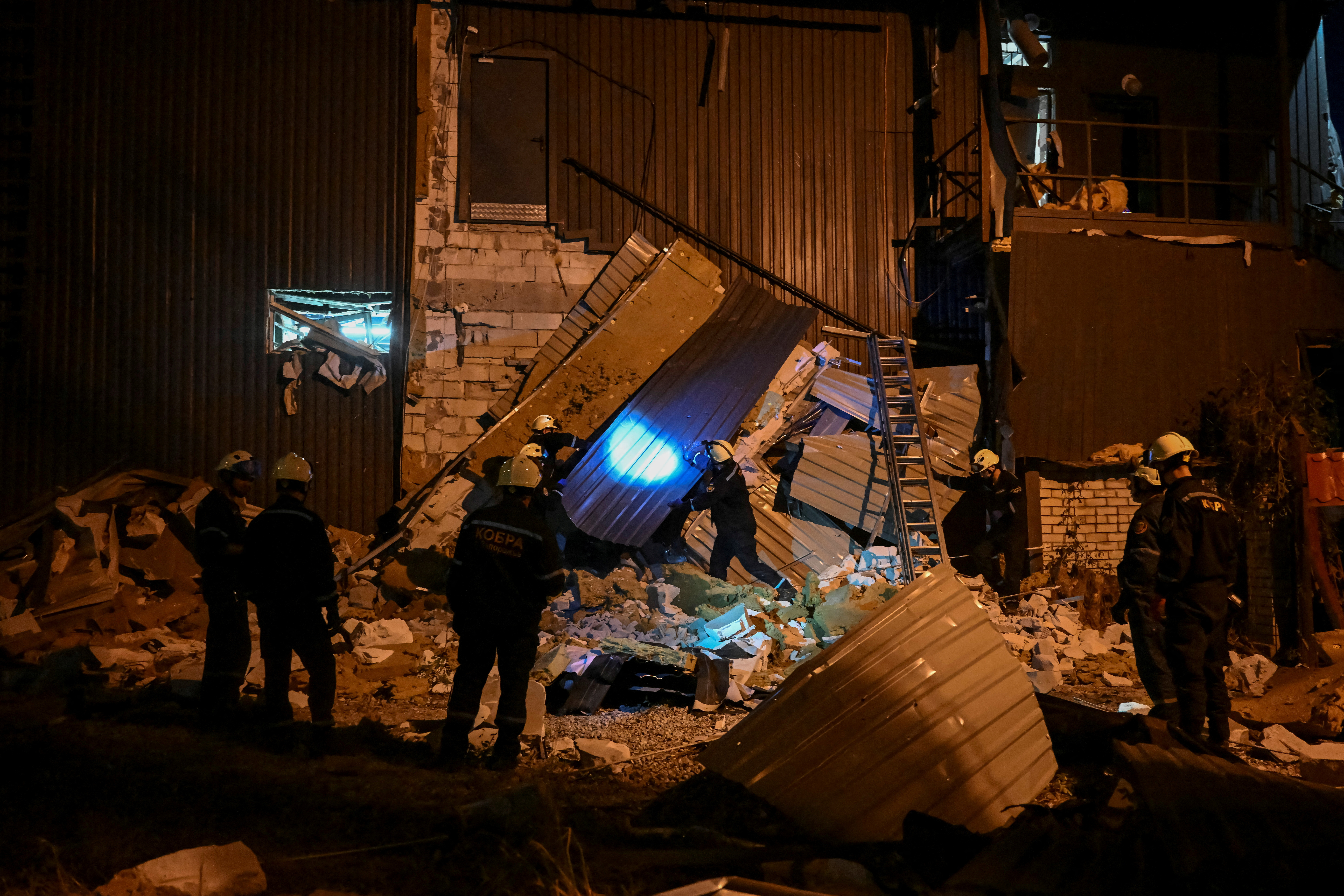 FILE PHOTO: Rescuers work at the site where a building was destroyed during a Russian missile strike, amid Russia's attack on Ukraine, in Zaporizhzhia, Ukraine August 9, 2023. REUTERS