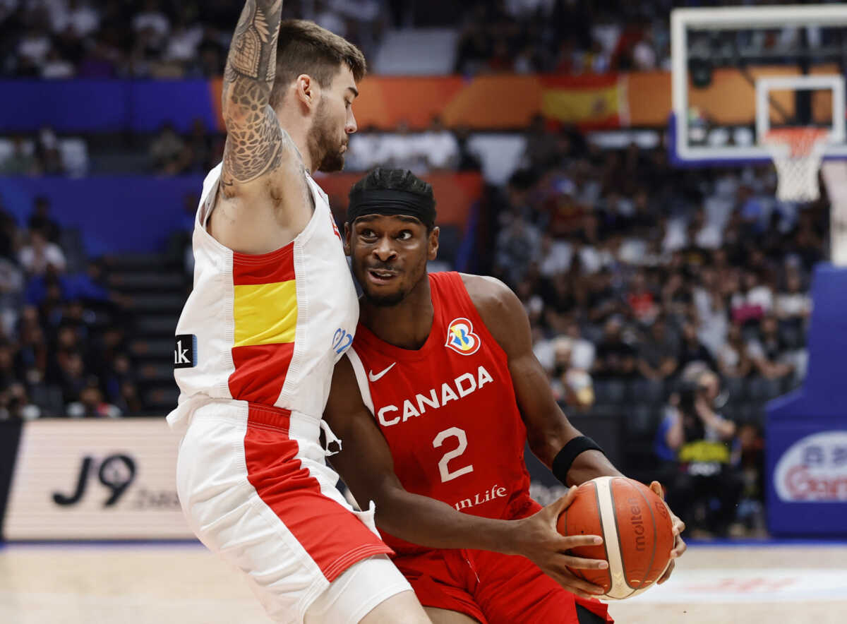 Basketball - FIBA World Cup 2023 - Second Round - Group L - Spain v Canada  - Indonesia Arena, Jakarta, Indonesia - September 3, 2023 Canada's Shai Gilgeous-Alexander in action with Spain's Juancho Hernangomez REUTERS
