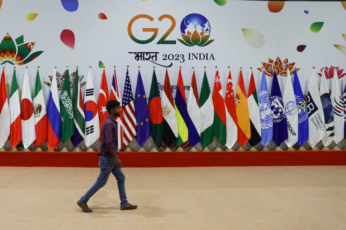 A man walks near flags ahead of G20 Summit in New Delhi, India, September 8, 2023. REUTERS
