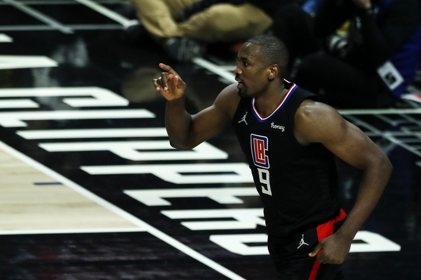 epa09726536 LA Clippers forward Serge Ibaka reacts after scoring during the second quarter of the NBA game between the Los Angeles Lakers and the Los Angeles Clippers at the Crypto.com Arena in Los Angeles, California, USA, 03 February 2022.  EPA