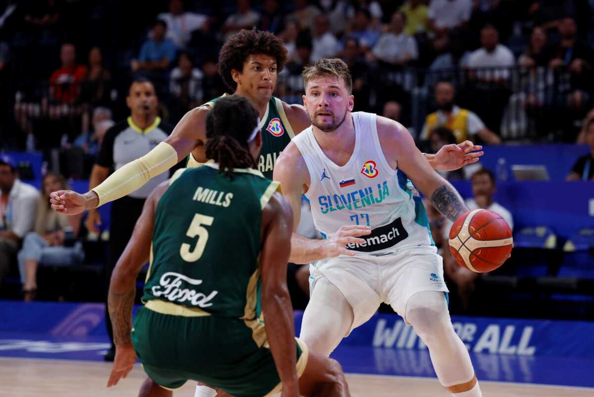 Basketball - FIBA World Cup 2023 - Second Round - Group K - Slovenia v Australia - Okinawa Arena, Okinawa, Japan - September 1, 2023 Slovenia's Luka Doncic in action with Australia's Matisse Thybulle and Patty Mills REUTERS