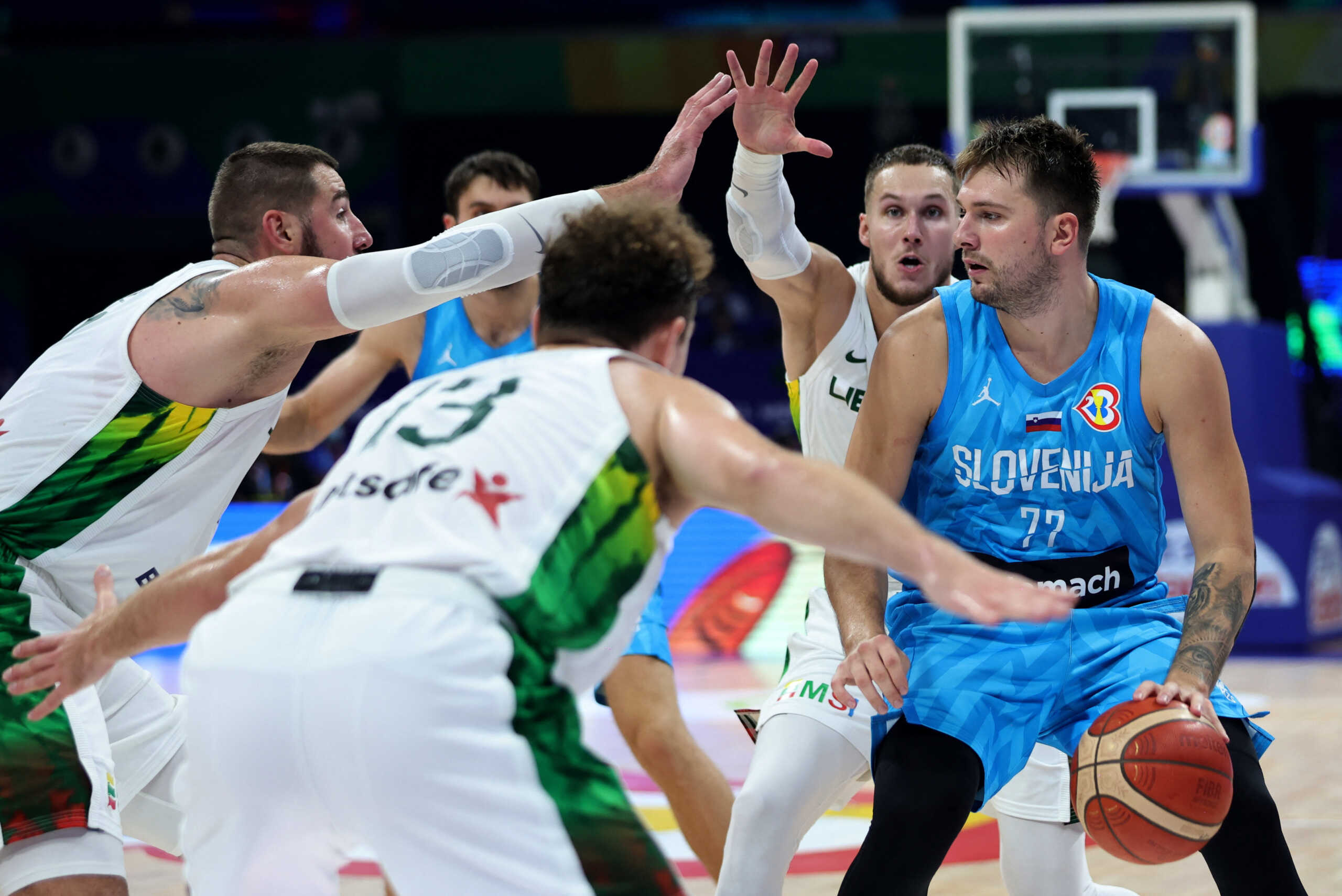 Basketball - FIBA World Cup 2023 - Classification Games 5-8 - Lithuania v Slovenia - Mall of Asia Arena, Manila, Philippines - September 7, 2023 Slovenia's Luka Doncic in action with Lithuania's Rokas Jokubaitis and teammates REUTERS