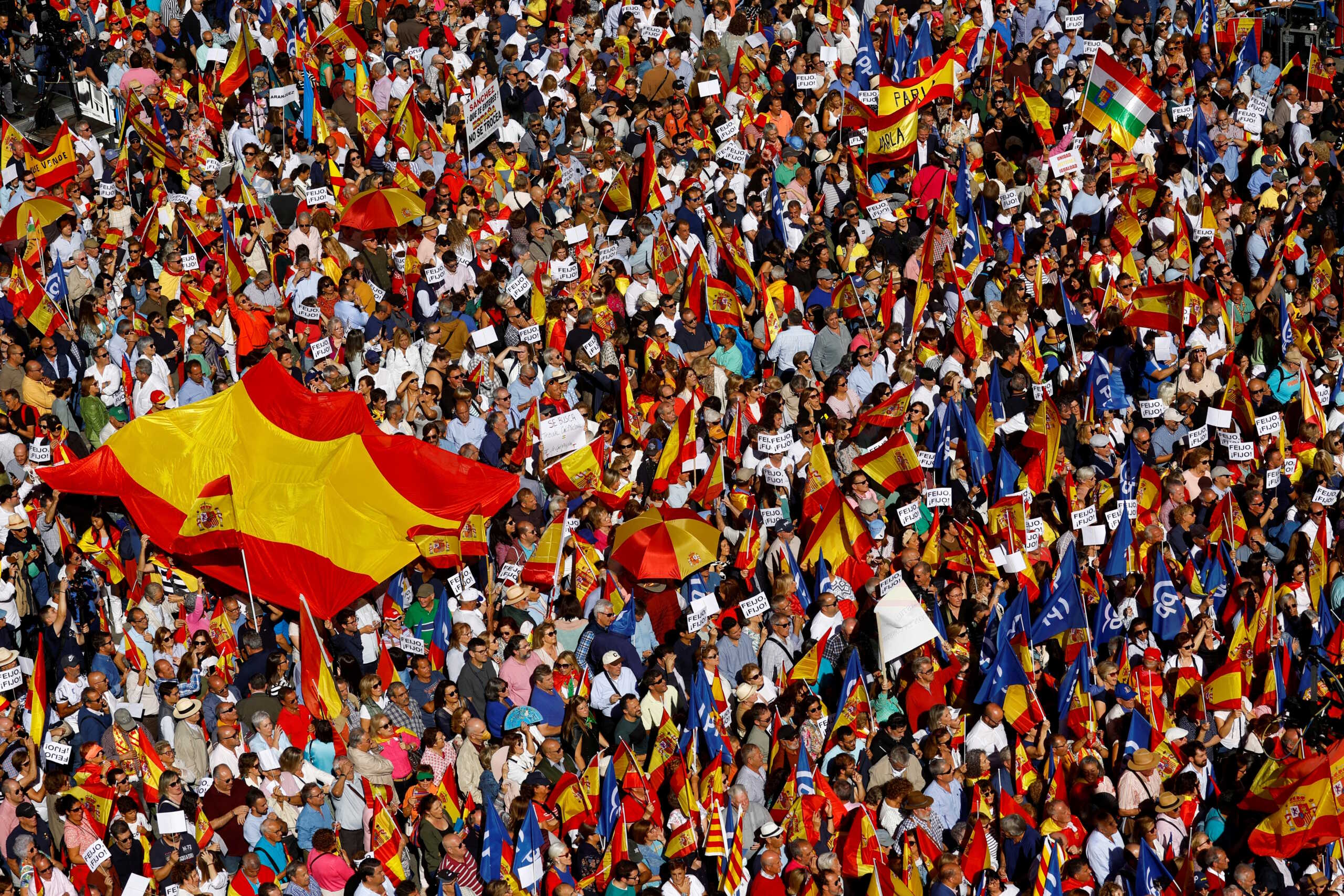 People hold Spanish flags ahead of a rally against a possible amnesty for Catalan separatist leaders in Madrid, Spain, September 24, 2023. REUTERS