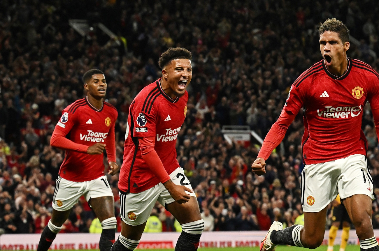 Soccer Football - Premier League - Manchester United v Wolverhampton Wanderers - Old Trafford, Manchester, Britain - August 14, 2023  Manchester United's Raphael Varane celebrates scoring their first goal with Jadon Sancho REUTERS