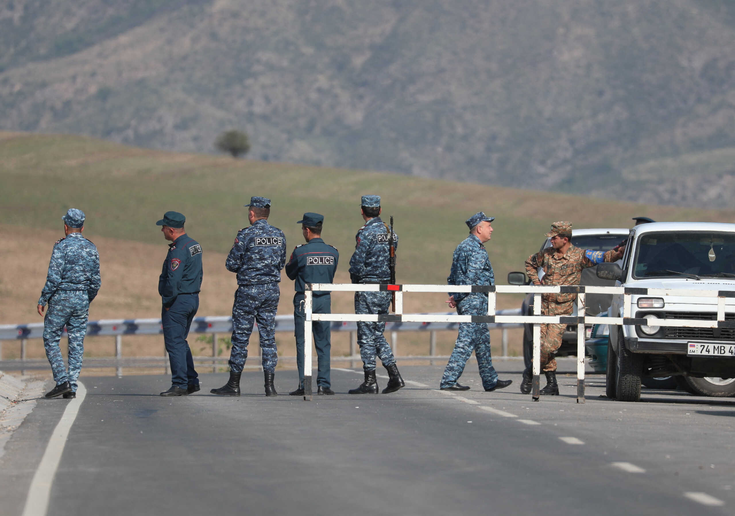 Armenian law enforcement officers stand at a checkpoint on a road leading to Azerbaijan's Nagorno-Karabakh region, near the village of Kornidzor, Armenia September 22, 2023. REUTERS