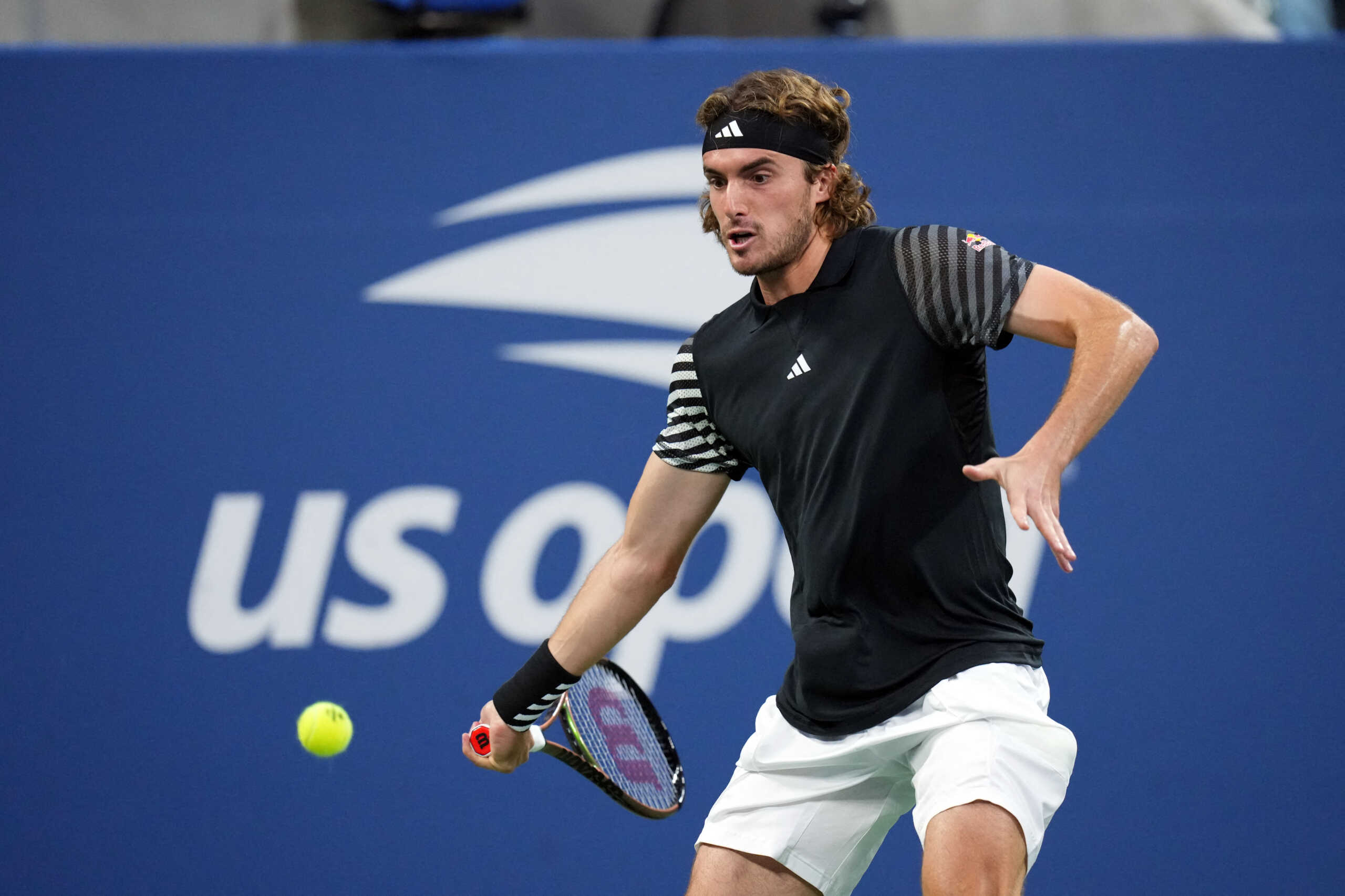 Aug 28, 2023; Flushing, NY, USA; Stefanos Tsitsipas of Greece hits to Milos Raonic of Canada on day one of the 2023 U.S. Open at the Billie Jean King Tennis Center. Mandatory Credit: Danielle Parhizkaran-USA TODAY Sports