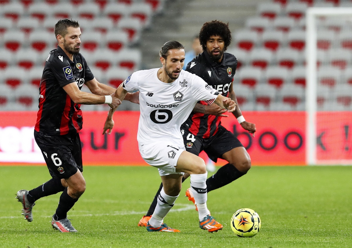 epa08773436 Yusuf Yazici (C) of Lille in action against Nice players Morgan Schneiderlin (L) and Dante (R) during the French Ligue 1 soccer match between OGC Nice and Lille OSC in Nice, France, 25 October 2020.  EPA